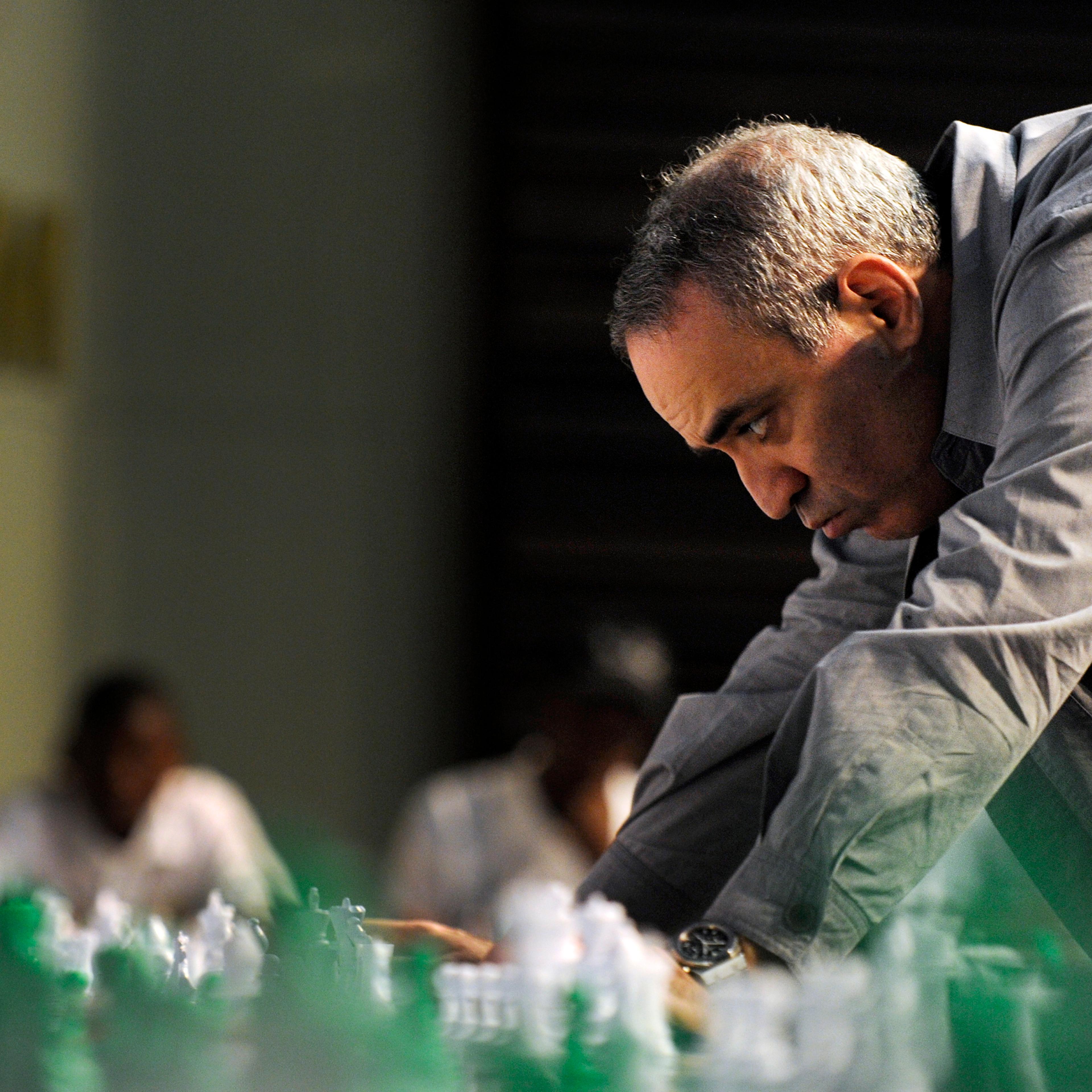 Former World Chess Champion Garry Kasparov plays a game of chess with school children on March 25, 2012 in Pretoria, South Africa.