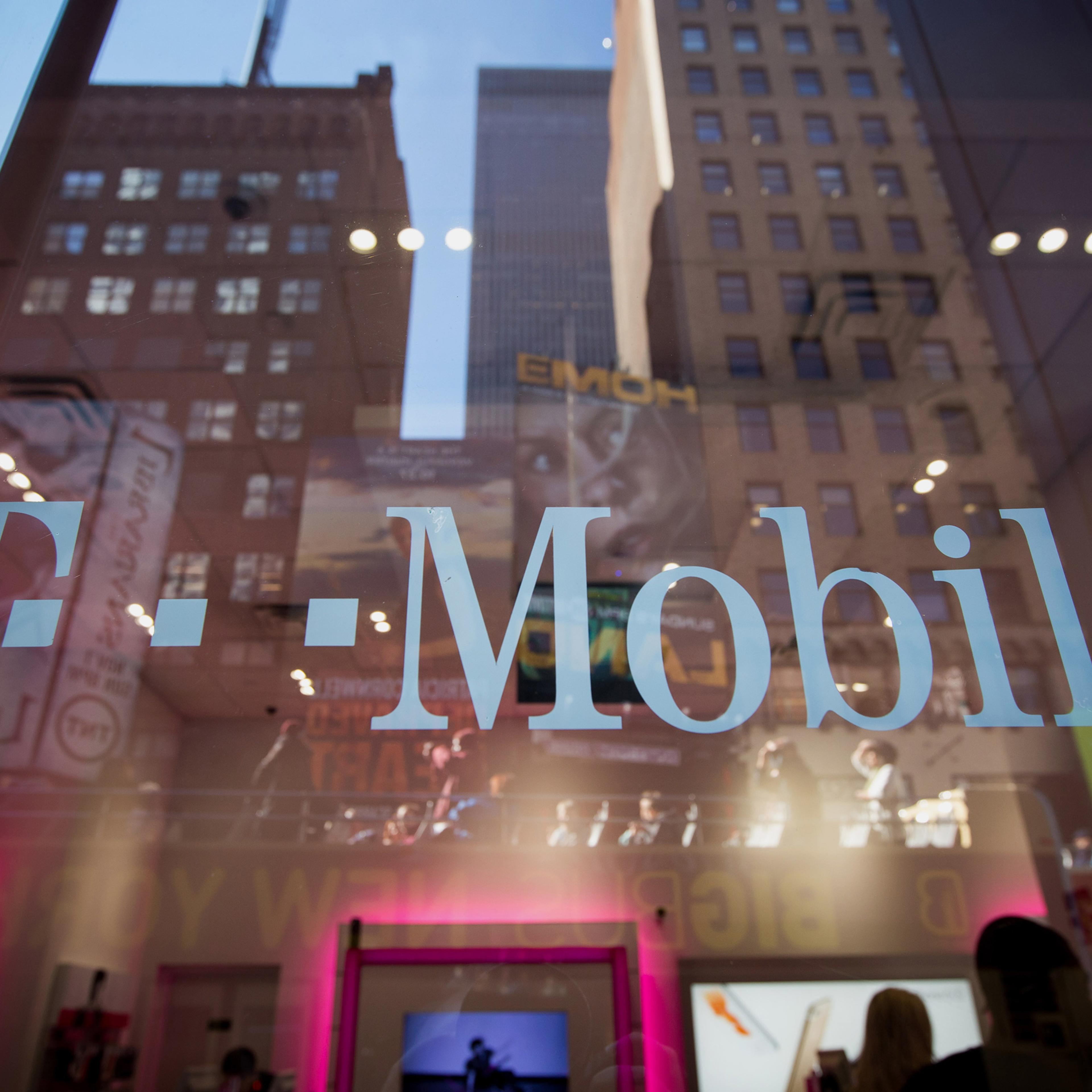 The T-Mobile US Inc. logo is displayed on a door at a T-Mobile US Inc. store in New York, U.S., on Monday, Oct. 26, 2015. T-Mobile US Inc. is scheduled to release earnings figures on October 27. Photographer: Michael Nagle/Bloomberg via Getty Images
