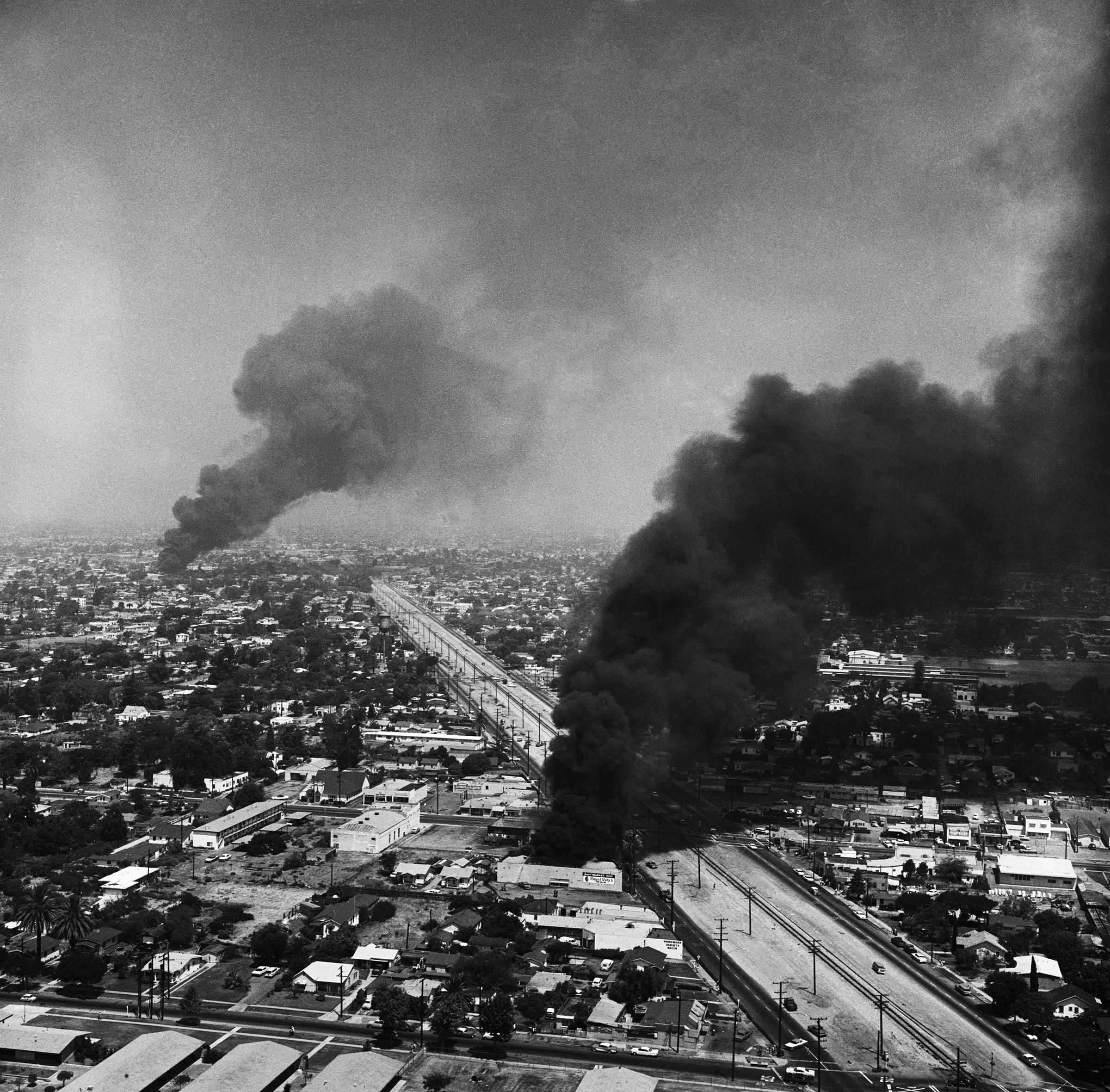 Black smoke darkens the sky over Southeast Los Angeles, during the fourth day of the six day rioting in the area on Aug. 16, 1965