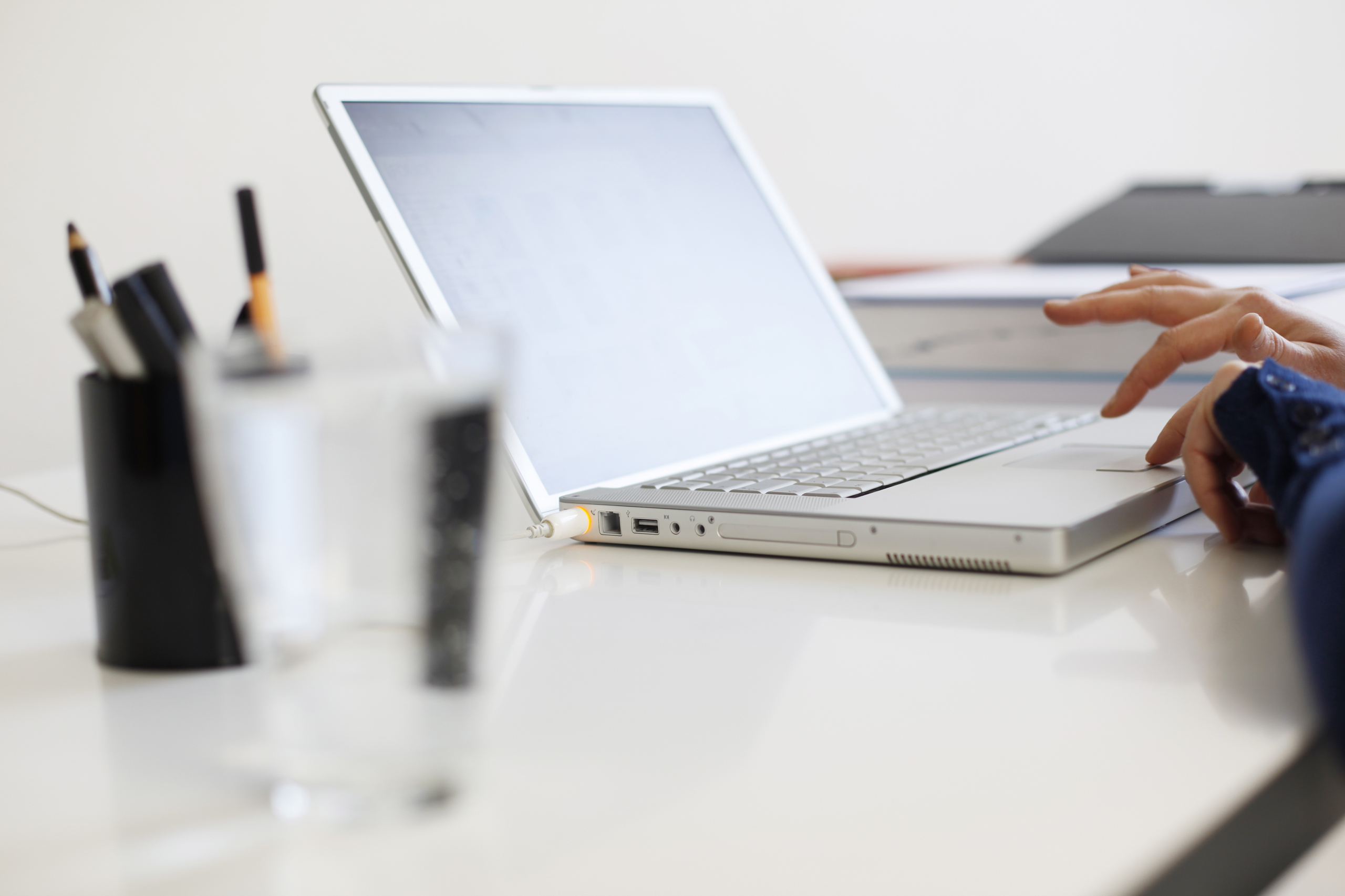 Close up of woman's hands using laptop at home