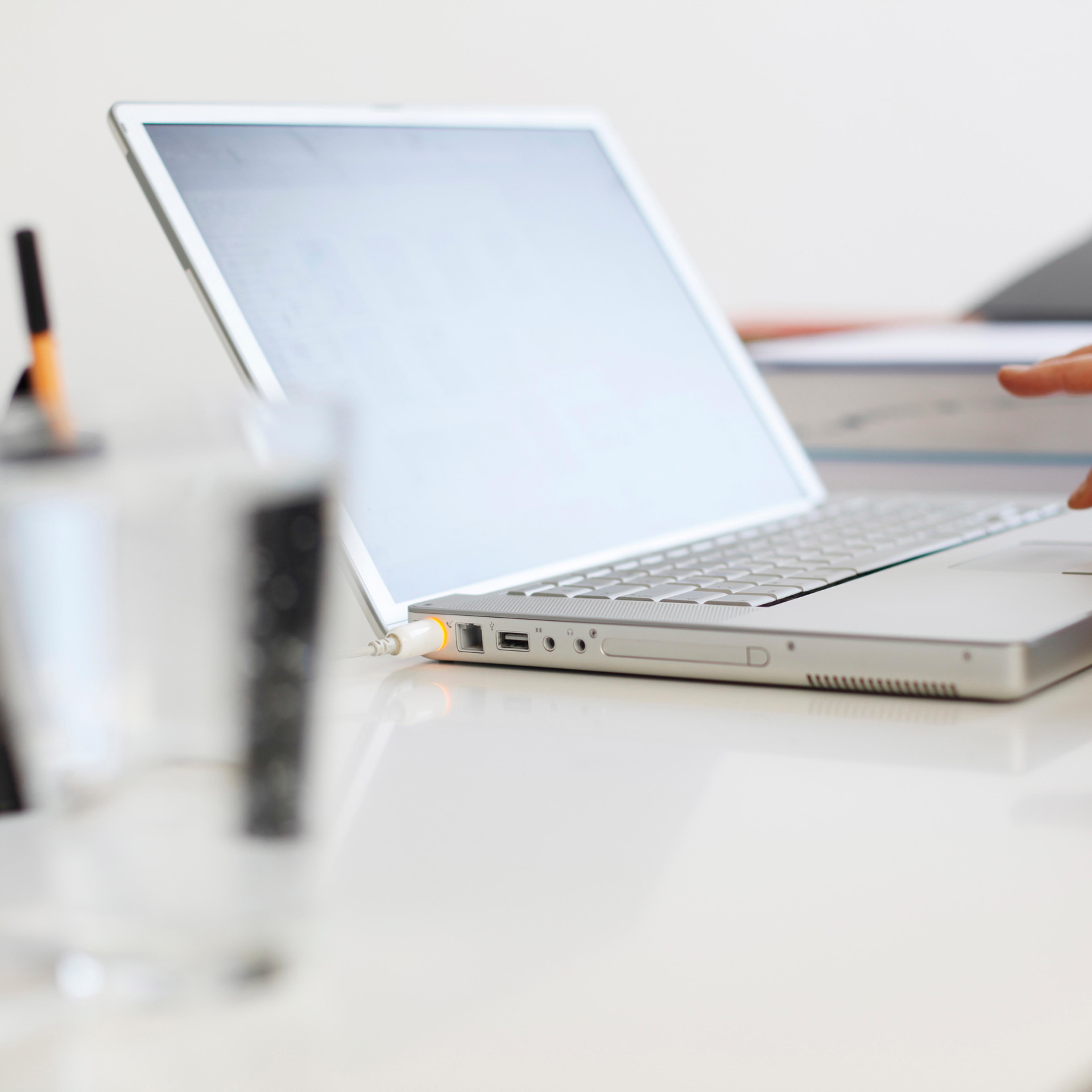 Close up of woman's hands using laptop at home