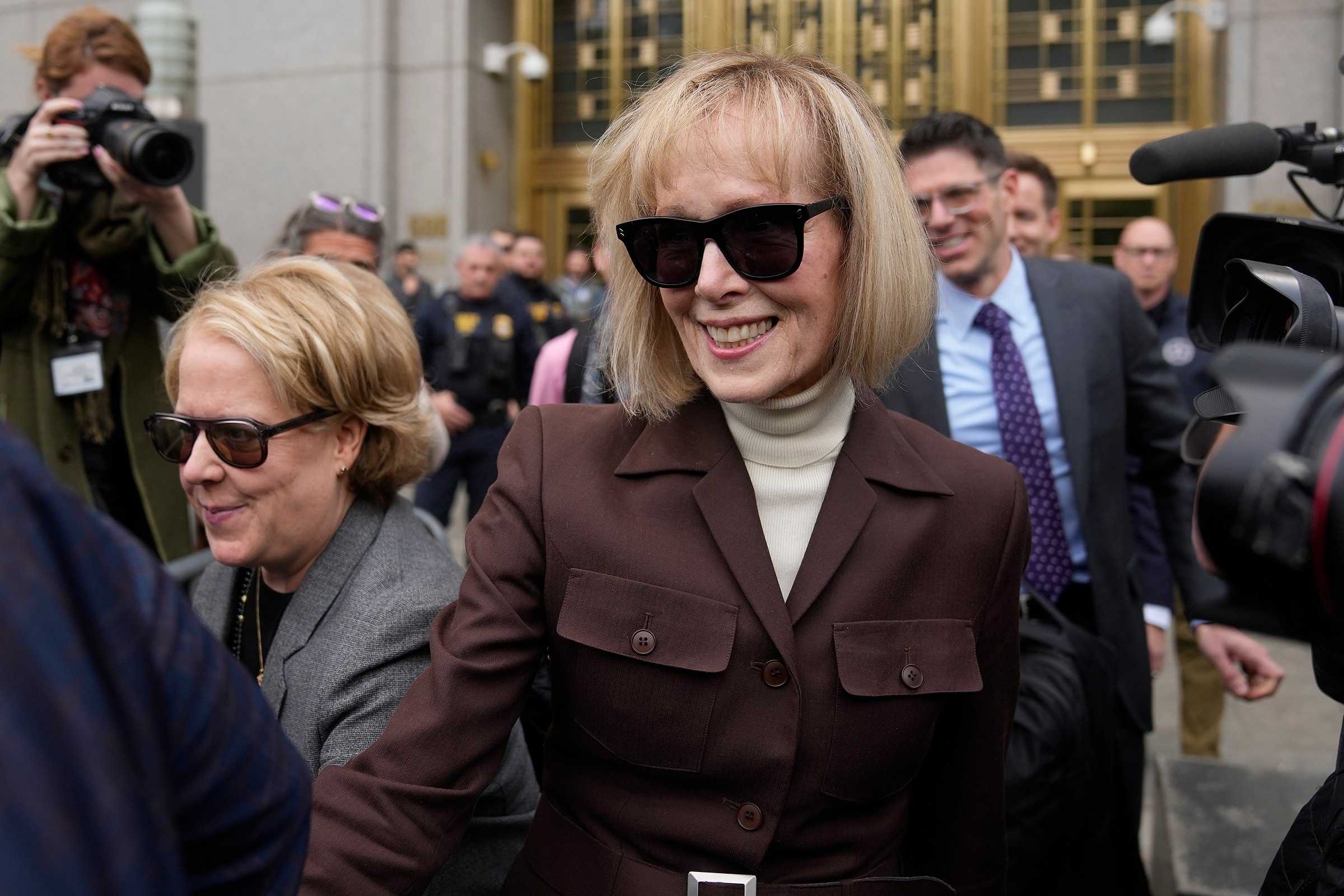 E. Jean Carroll, center, walks out of Manhattan federal court, Tuesday, May 9, 2023, 2023, in New York