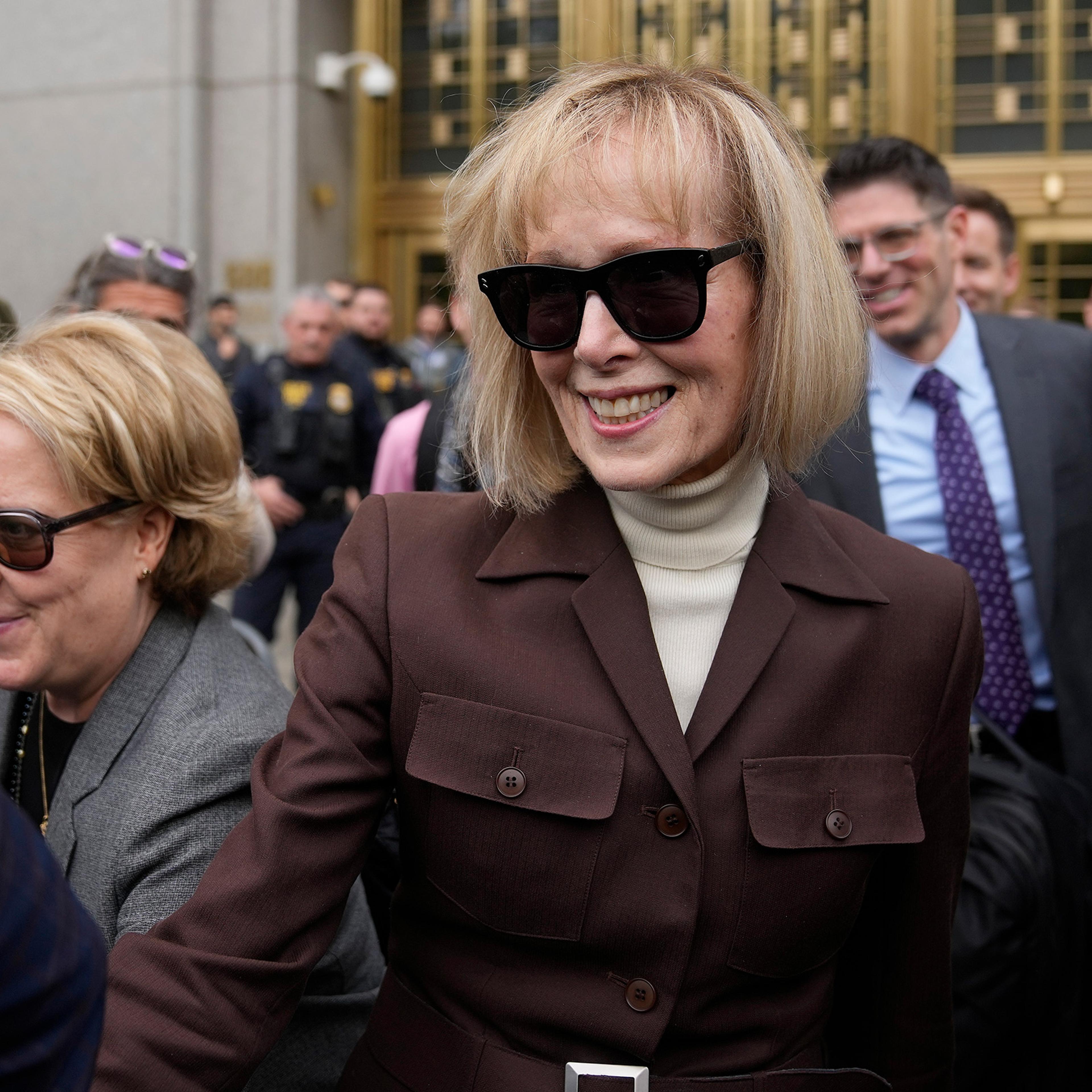 E. Jean Carroll, center, walks out of Manhattan federal court, Tuesday, May 9, 2023, 2023, in New York