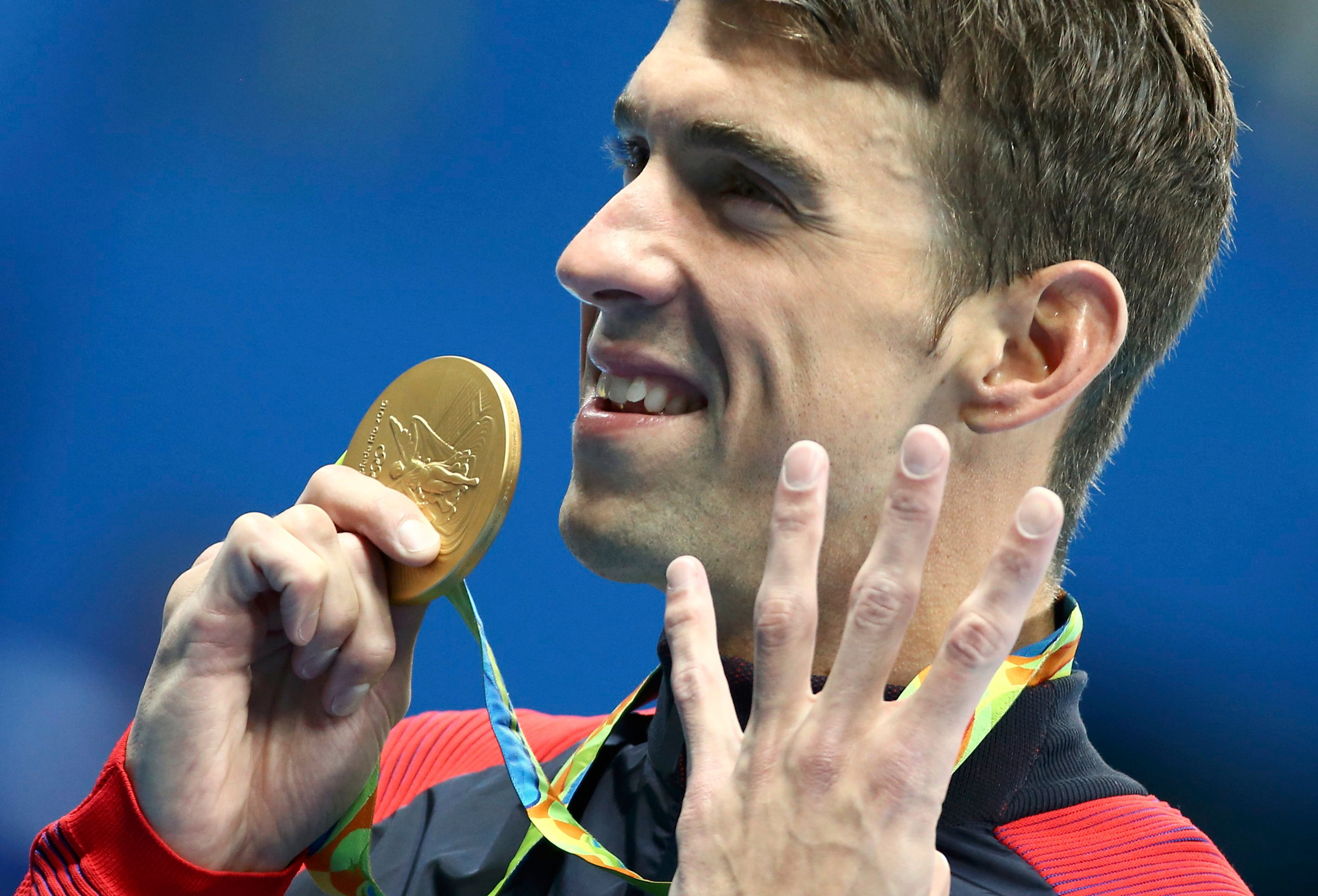 2016 Rio Olympics - Swimming - Victory Ceremony - Men's 200m Individual Medley Victory Ceremony - Olympic Aquatics Stadium - Rio de Janeiro, Brazil - 11/08/2016. Michael Phelps (USA) of USA poses with his gold medal. REUTERS/Michael Dalder FOR EDITORIAL 