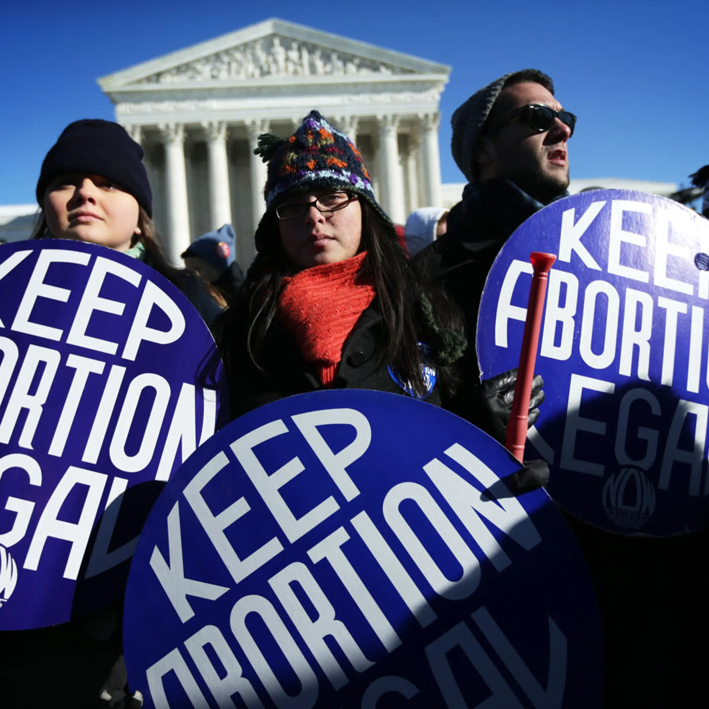 Pro-choice activists hold signs as marchers of the annual March for Life arrive in front of the U.S. Supreme Court Jan. 22, 2014 on Capitol Hill in Washington, D.C.