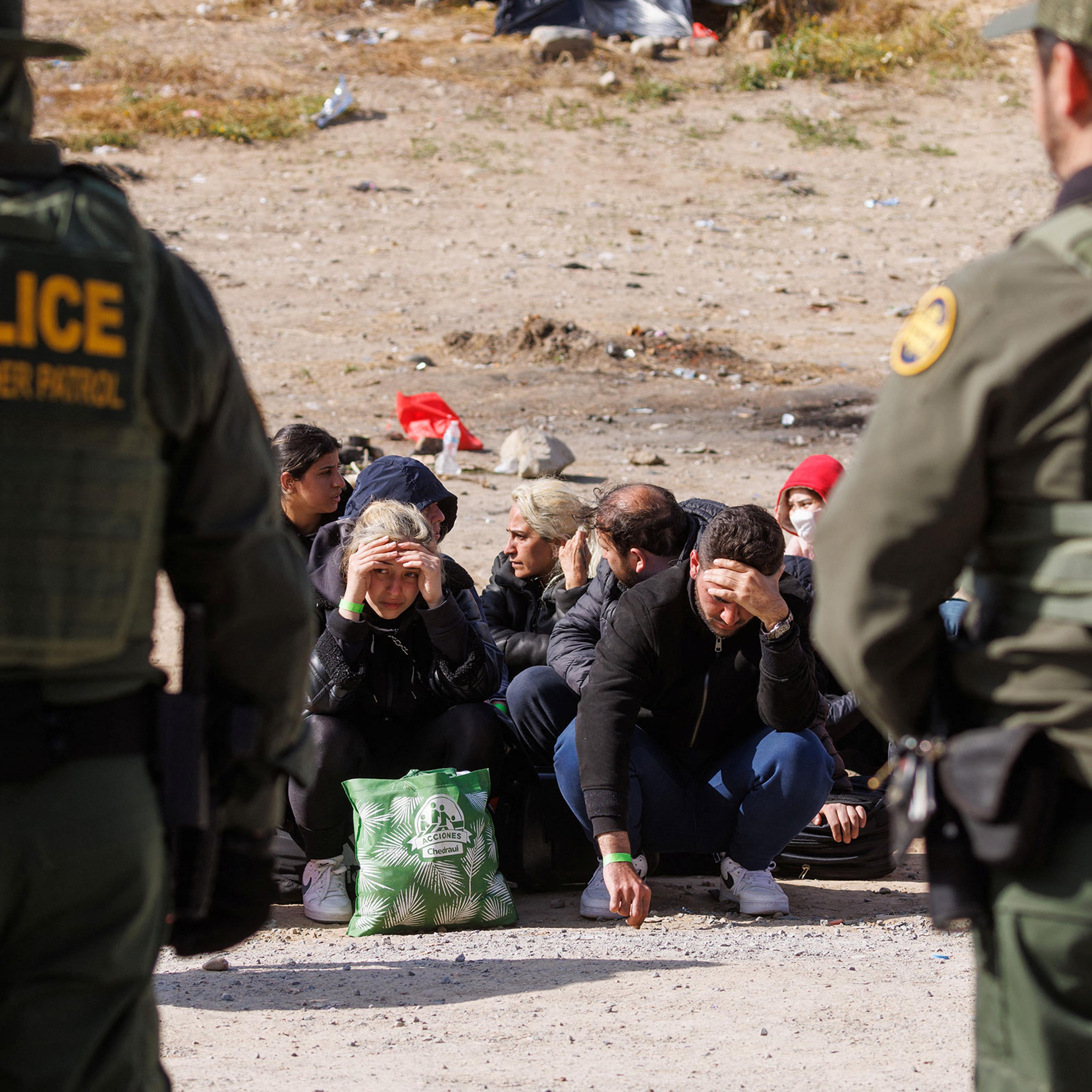 U.S. Border Patrol organize migrants after they gathered between primary and secondary border fences as the United States prepares to lift COVID-19 era Title 42 restrictions that have blocked migrants at the U.S.-Mexico border from seeking asylum since 2