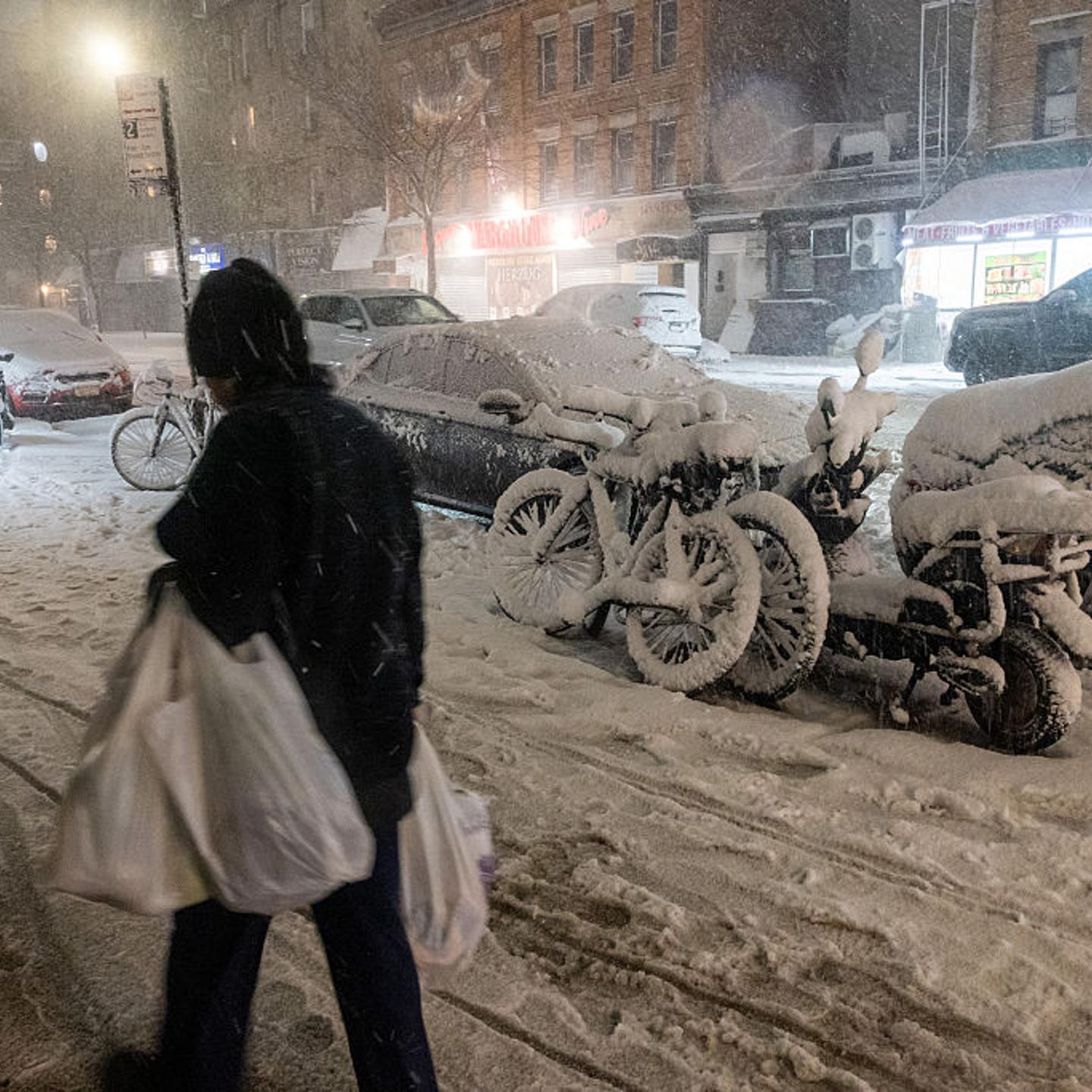 People walk through the streets as blizzard conditions arrive in the Brooklyn borough of New York City on Feb. 22, 2026.