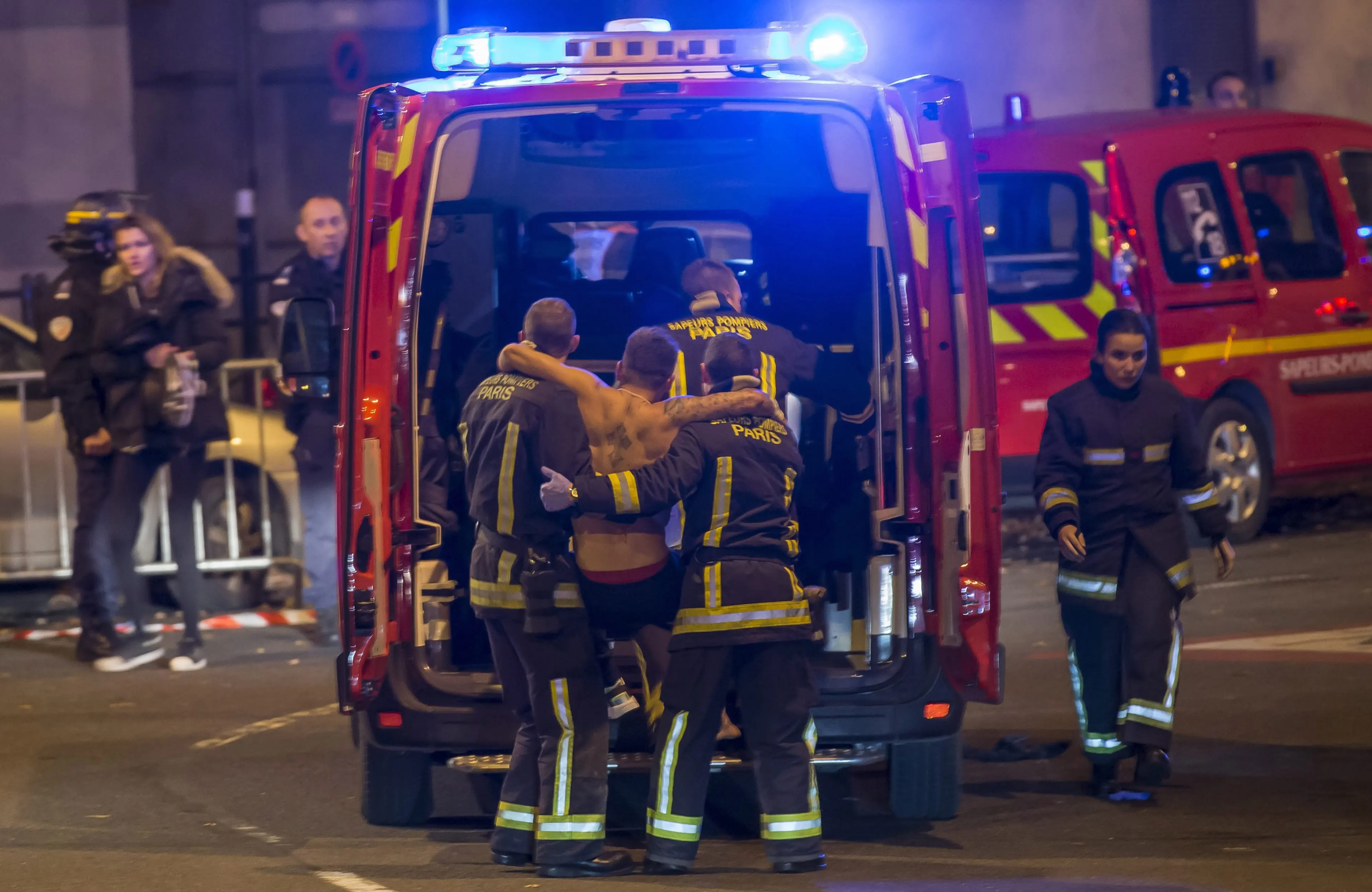Wounded people are evacuated from the Stade de France in Saint Denis, outside of Paris on Nov. 13, 2015.