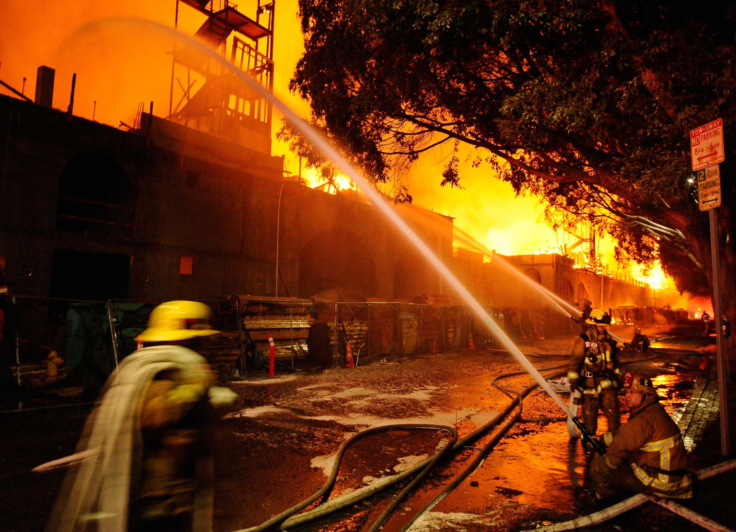 Los Angeles city firefighters battle a massive fire at a seven-story downtown apartment complex under construction in Los Angeles