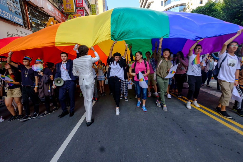 flying a huge rainbow flag, participants at the annual