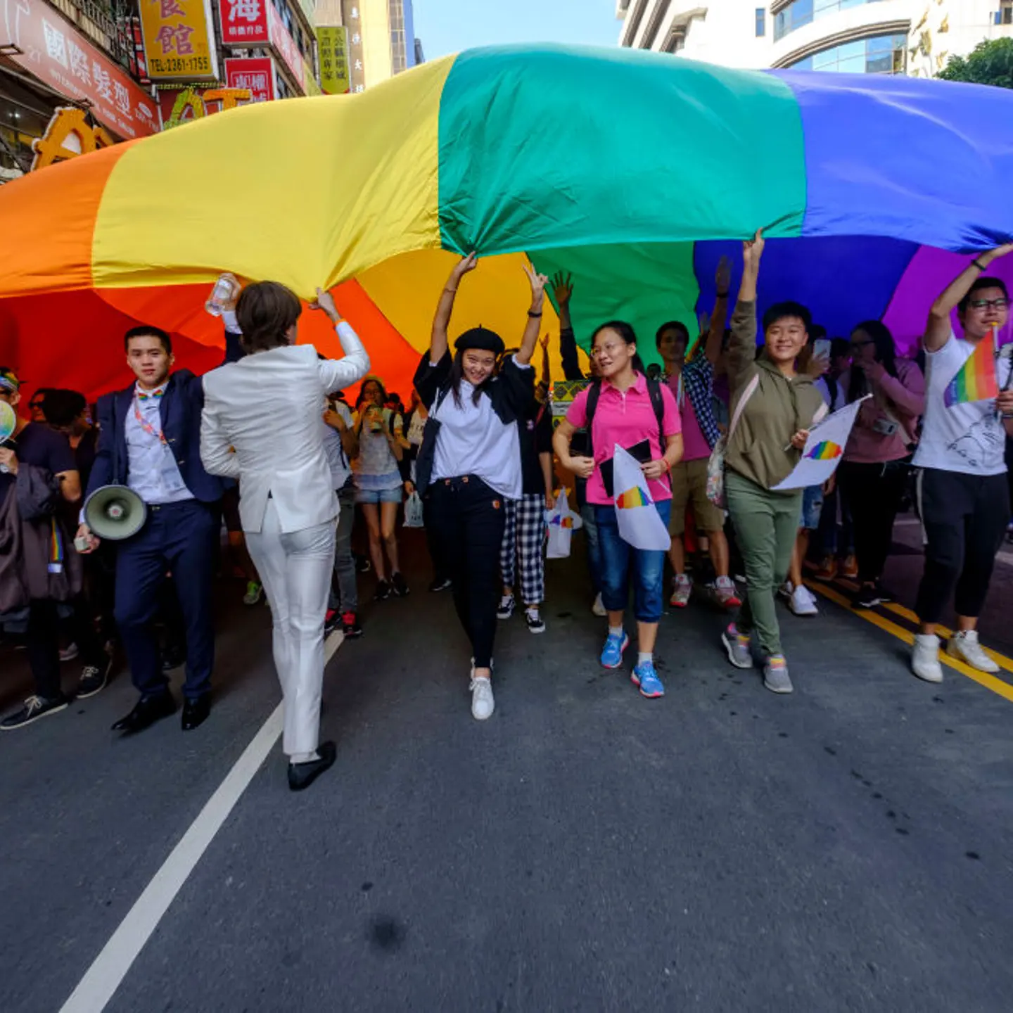 flying a huge rainbow flag, participants at the annual