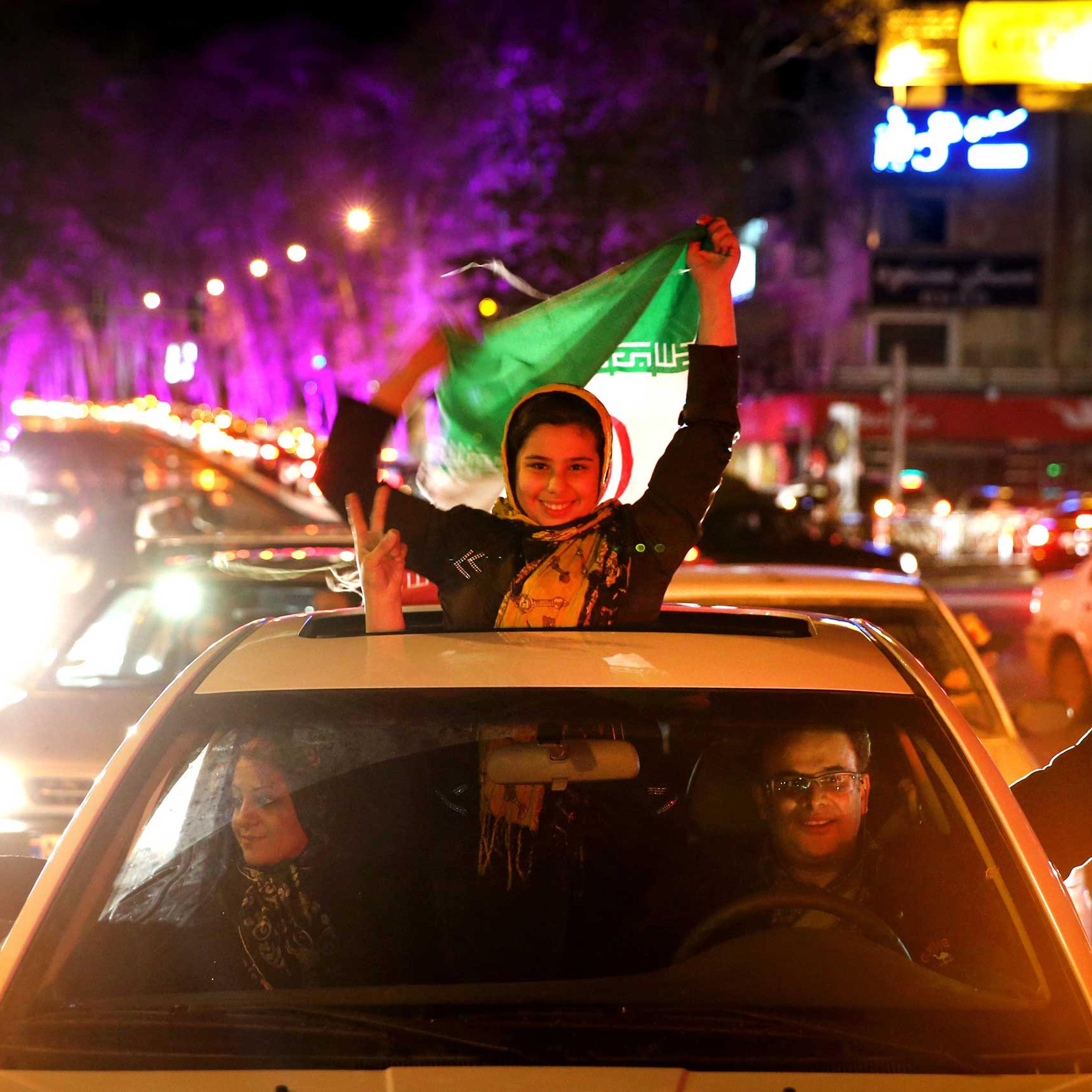 Iranians celebrate Iran's nuclear agreement with world powers on a street in northern Tehran, Iran, on Thursday, Apr. 2, 2015.