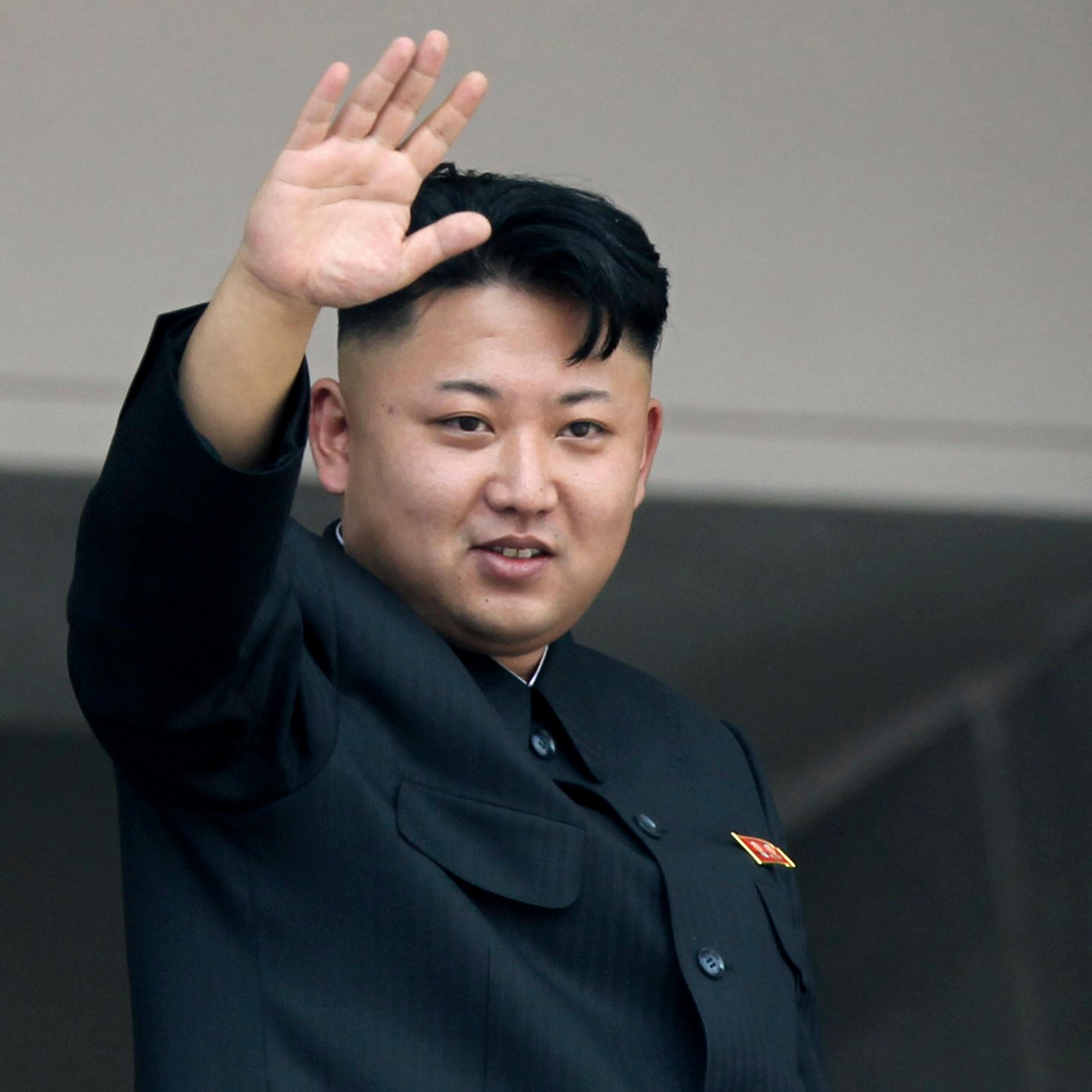 Kim Jong Un waves to spectators and participants of a mass military parade celebrating the 60th anniversary of the Korean War armistice in Pyongyang on July 27, 2013.