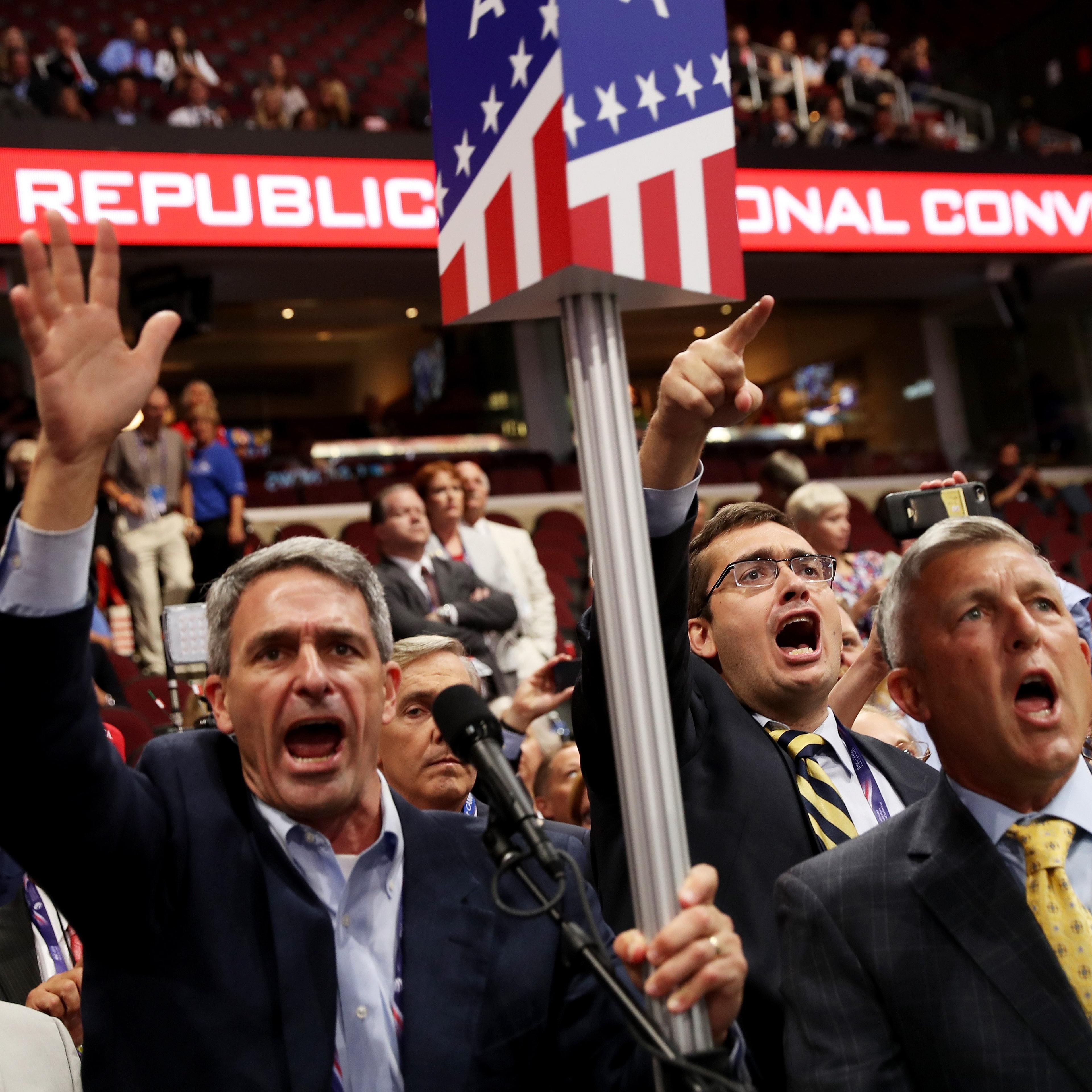 Former Virginia Attorney General Ken Cuccinelli, second left, along with other delegates from Virginia chant for a rule call vote on the first day of the Republican National Convention on July 18, 2016 at the Quicken Loans Arena in Cleveland.