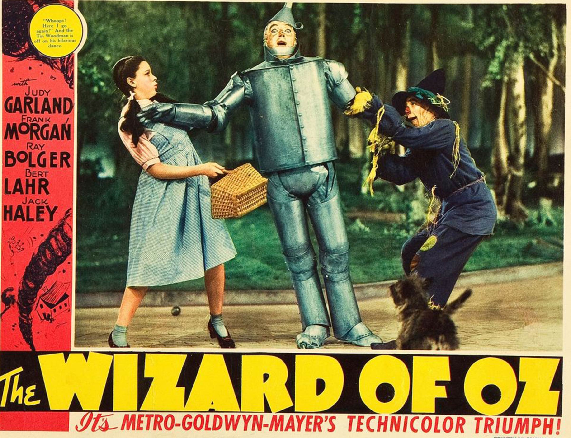 A 1939 publicity poster for <i>The Wizard Of Oz</i> for display in the lobby of movie theaters. Pictured, from left: Judy Garland, Jack Haley, Ray Bolger; bottom: Toto.
