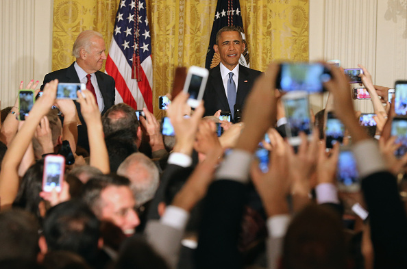 U.S. President Barack Obama (R) and Vice President Joe Biden attend a reception for LGBT Pride Month in the East Room of the White House June 24, 2015 in Washington, DC.