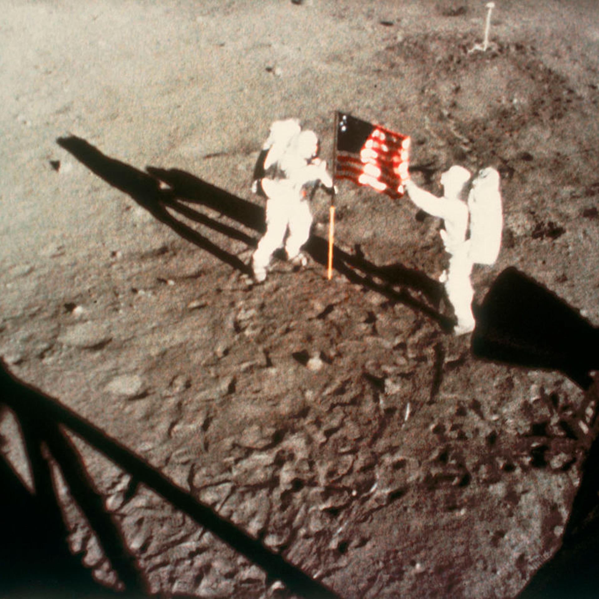 Astronauts Armstrong and Aldrin unfurling the US flag on the Moon, 1969.