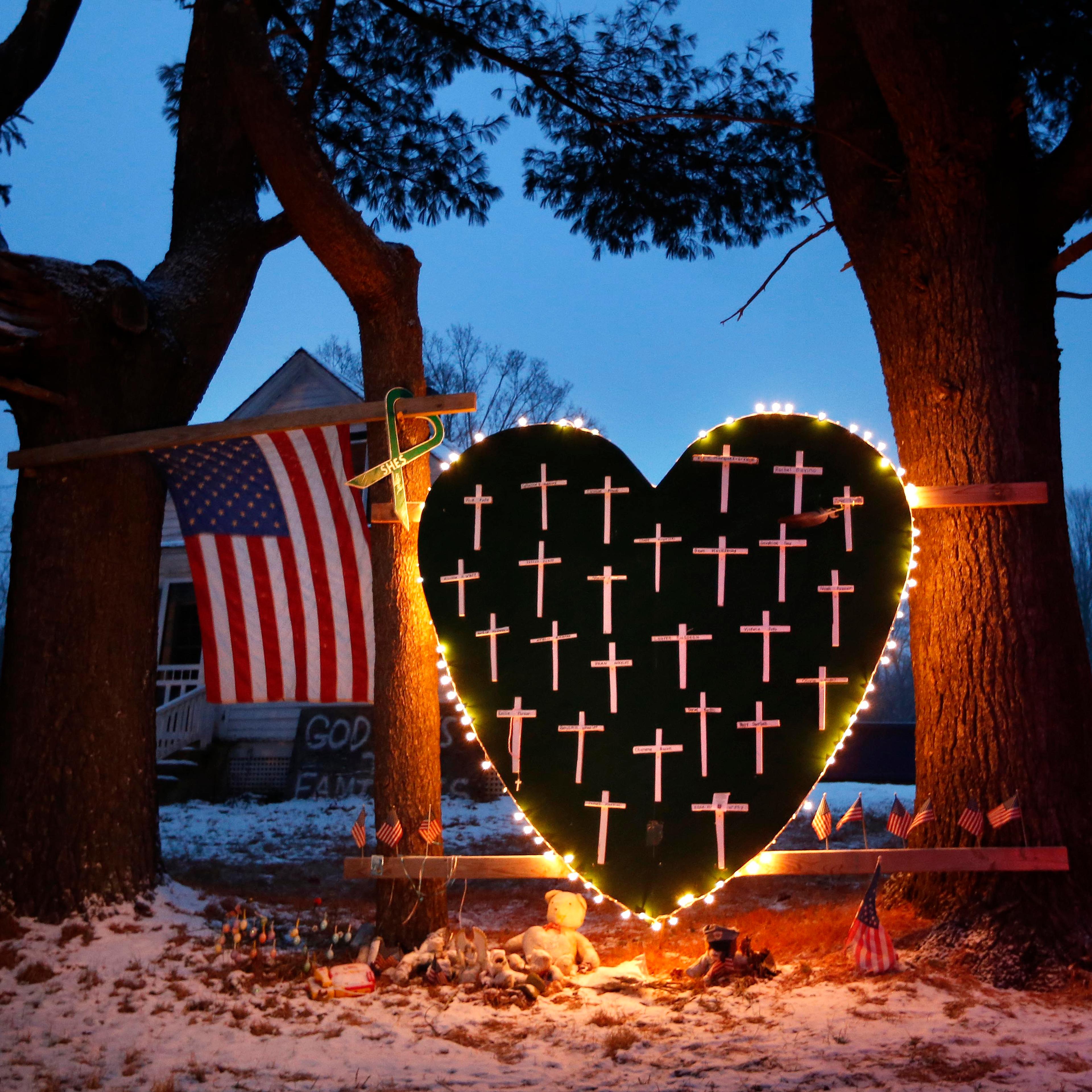 A makeshift memorial with crosses for the victims of the Sandy Hook massacre stands outside a home in Newtown, Conn., on Dec. 14, 2013, the one-year anniversary of the shootings.
