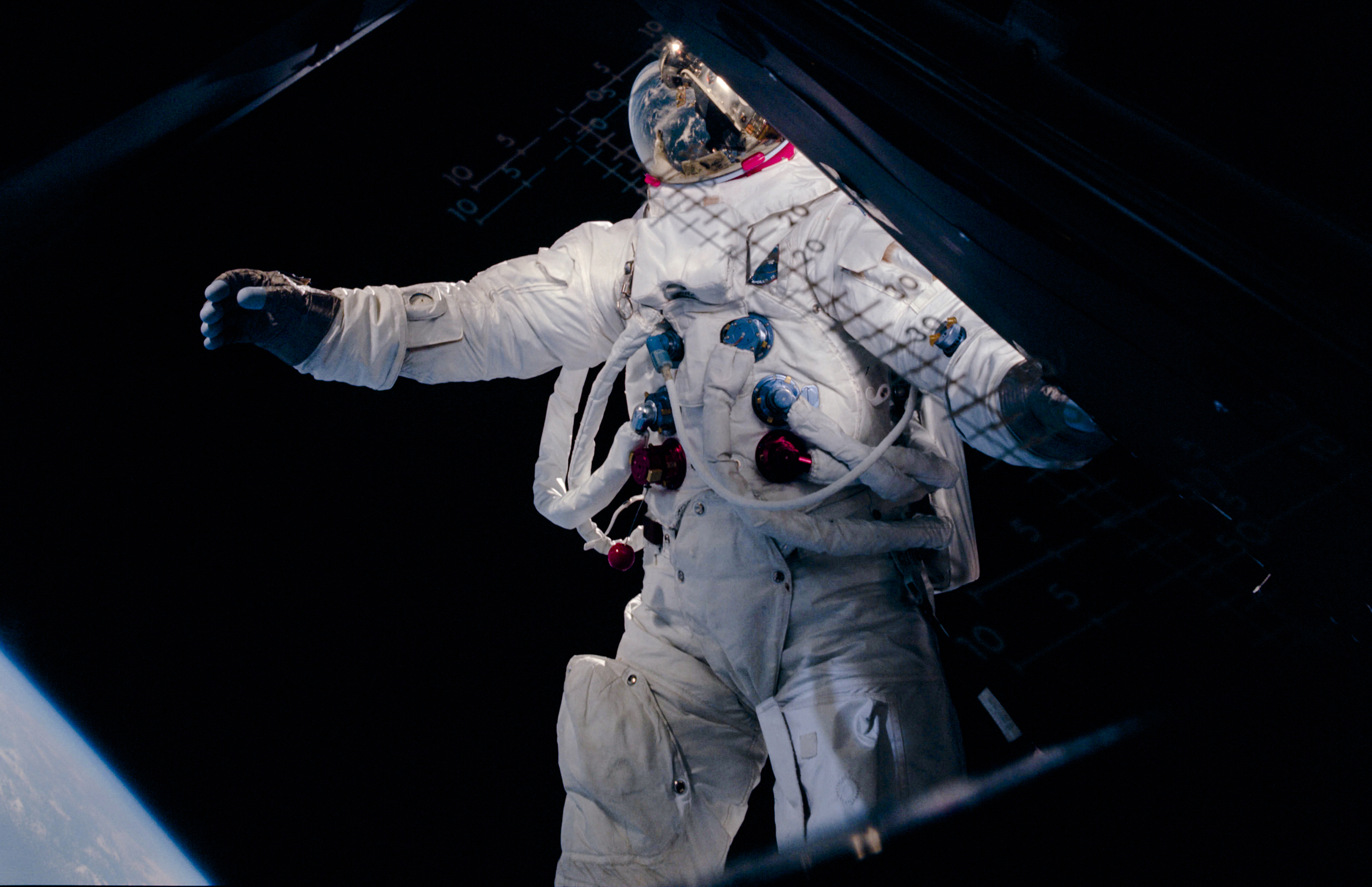 Rusty Schweickart, during a spacewalk in Earth orbit. Here, Schweickart may be trying to regain his balance by pinwheeling his arm forward. The result, however, gave him the look more of a man in full stride.