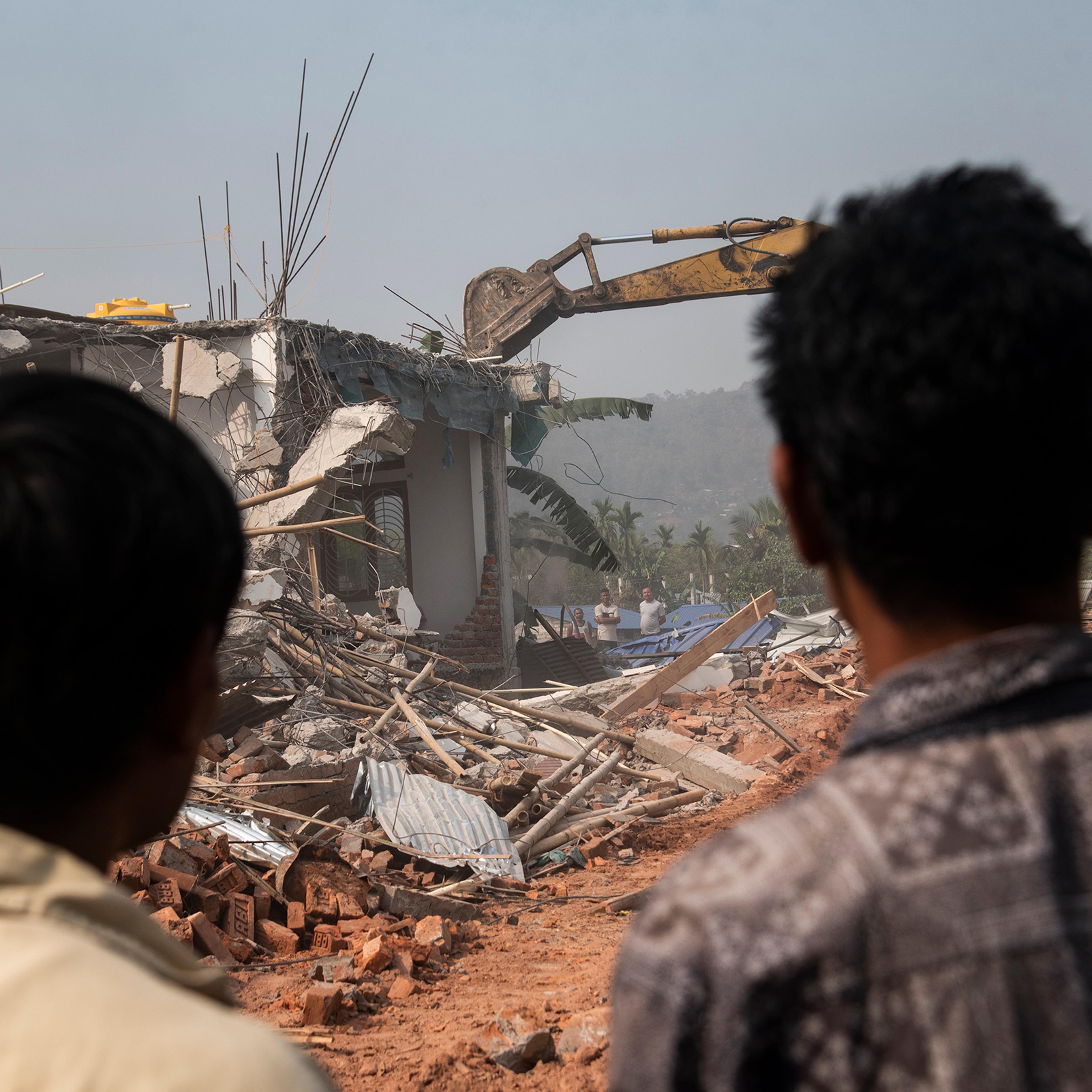 A bulldozer being used to demolish alleged illegal structures during an anti-encroachment eviction drive by Guwahati Metropolitan Development Authority, on Feb. 27 in Guwahati, India.