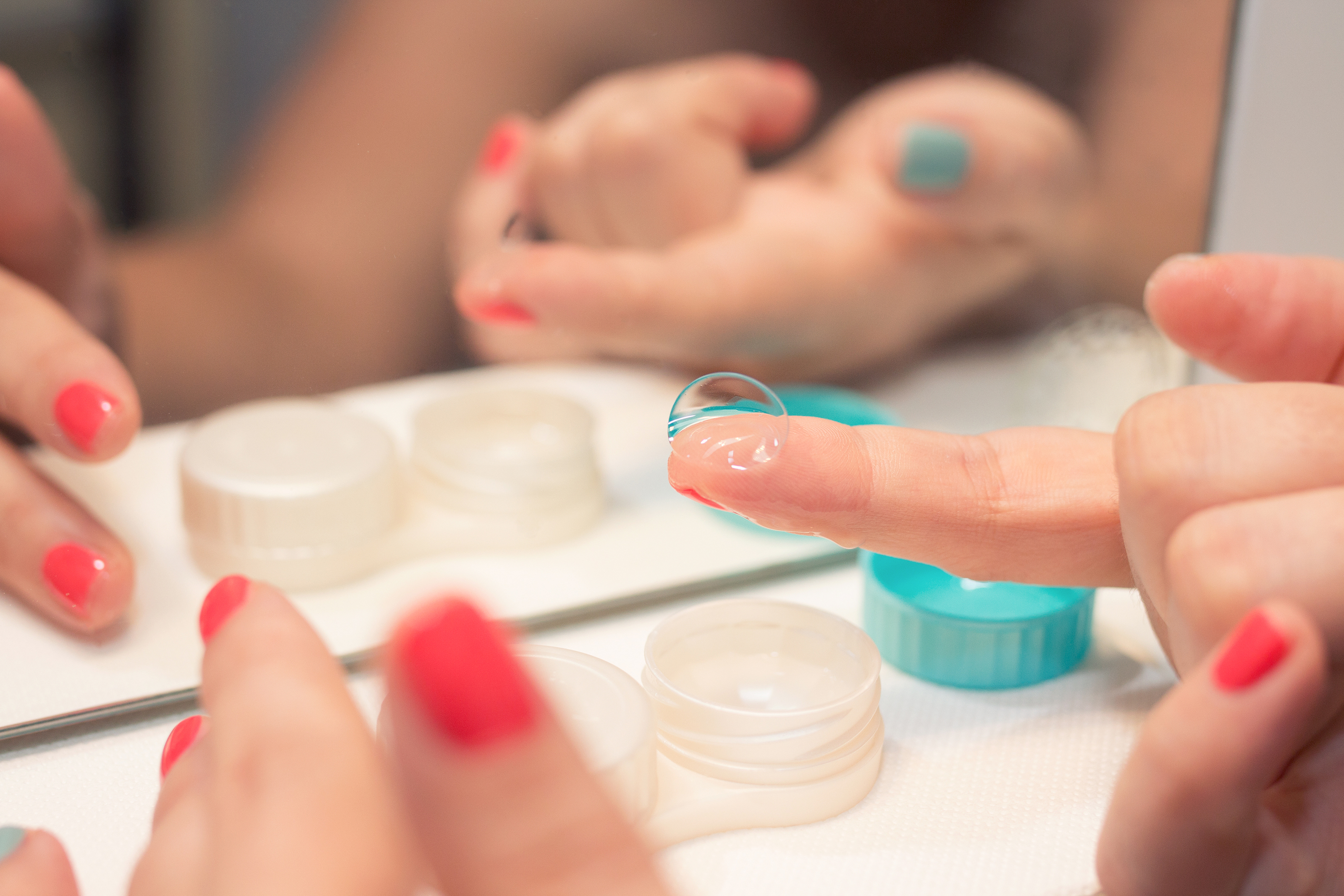 Female hands holding lens