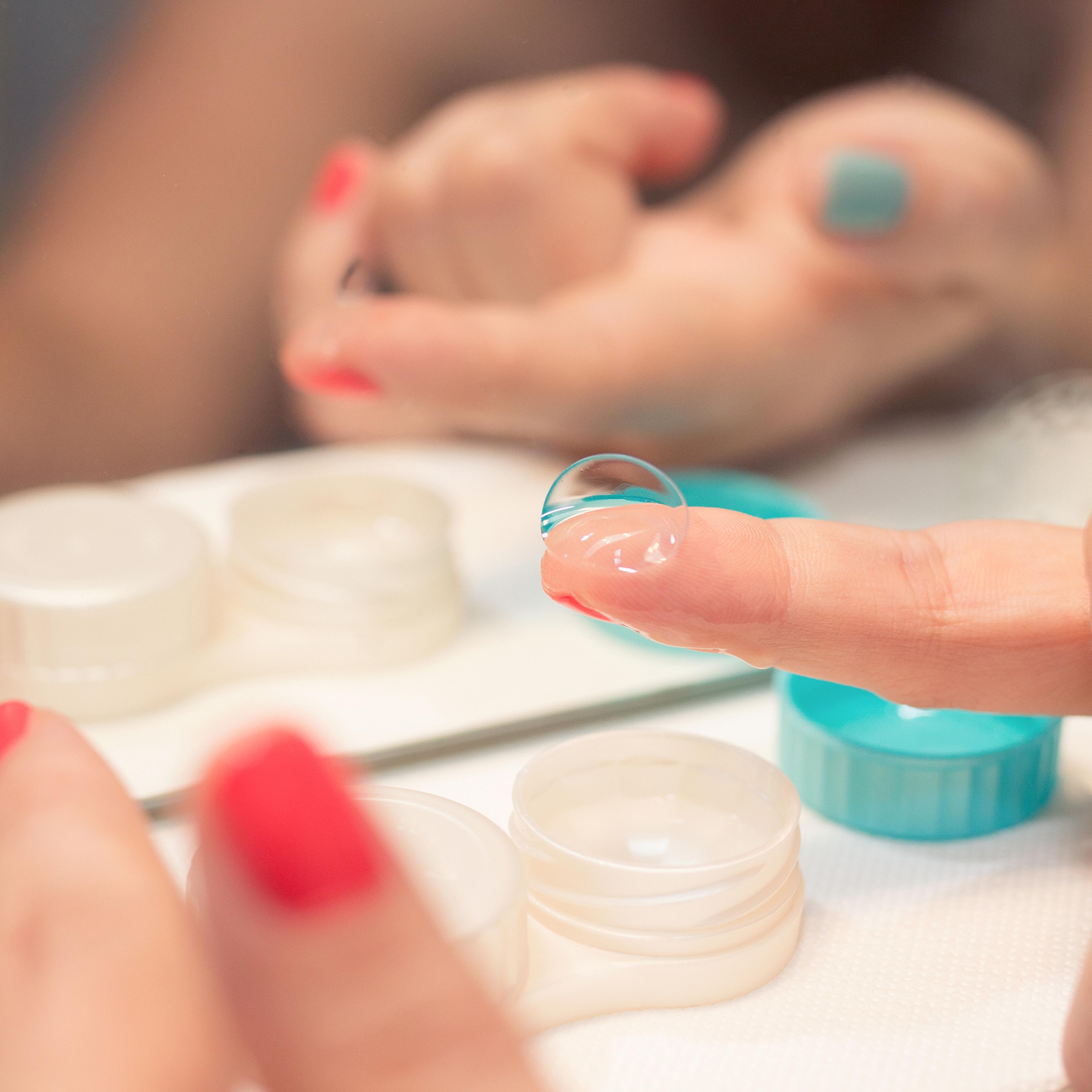 Female hands holding lens