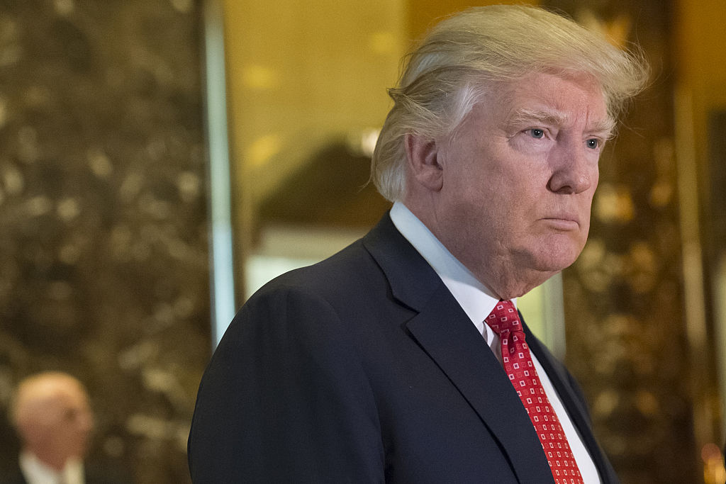 President-elect Donald Trump listens to members of the media in the lobby of Trump Tower in New York on Jan. 8, 2017.