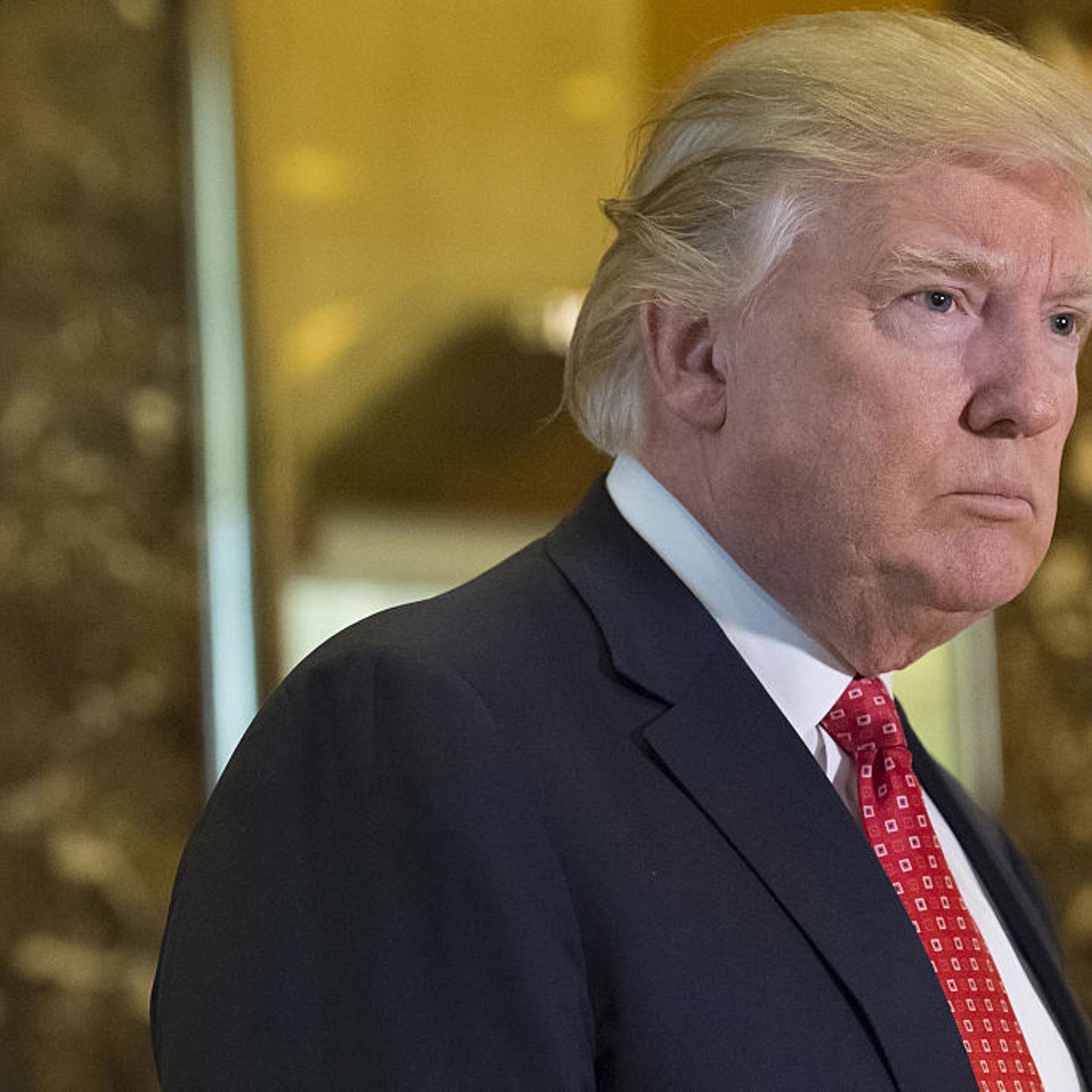 President-elect Donald Trump listens to members of the media in the lobby of Trump Tower in New York on Jan. 8, 2017.