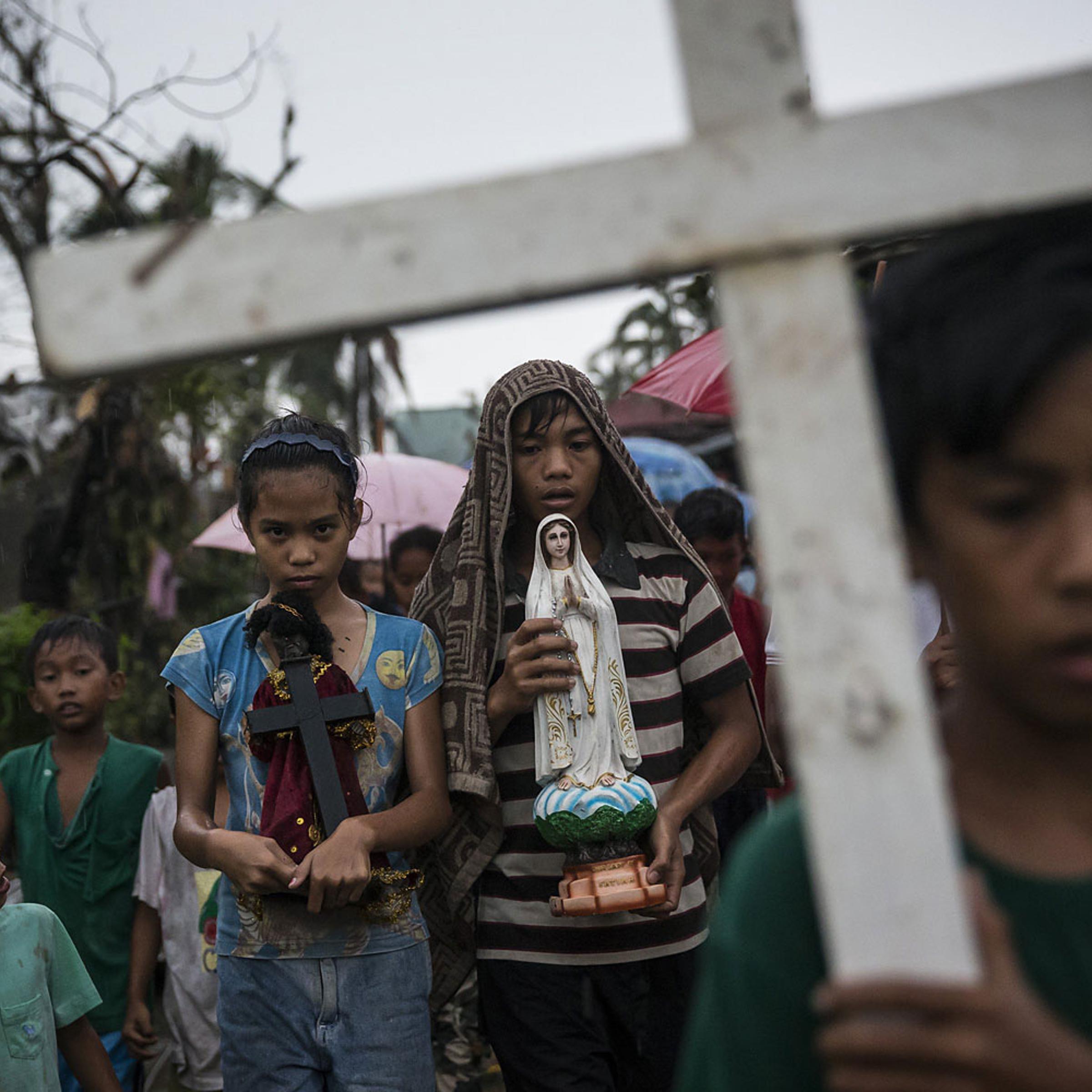 Villagers carry religious statues during a procession before taking part in a Latin mass ceremony at a local Chapel in Santa Rita township on November 22, 2013 in Eastern Samar, Philippines.