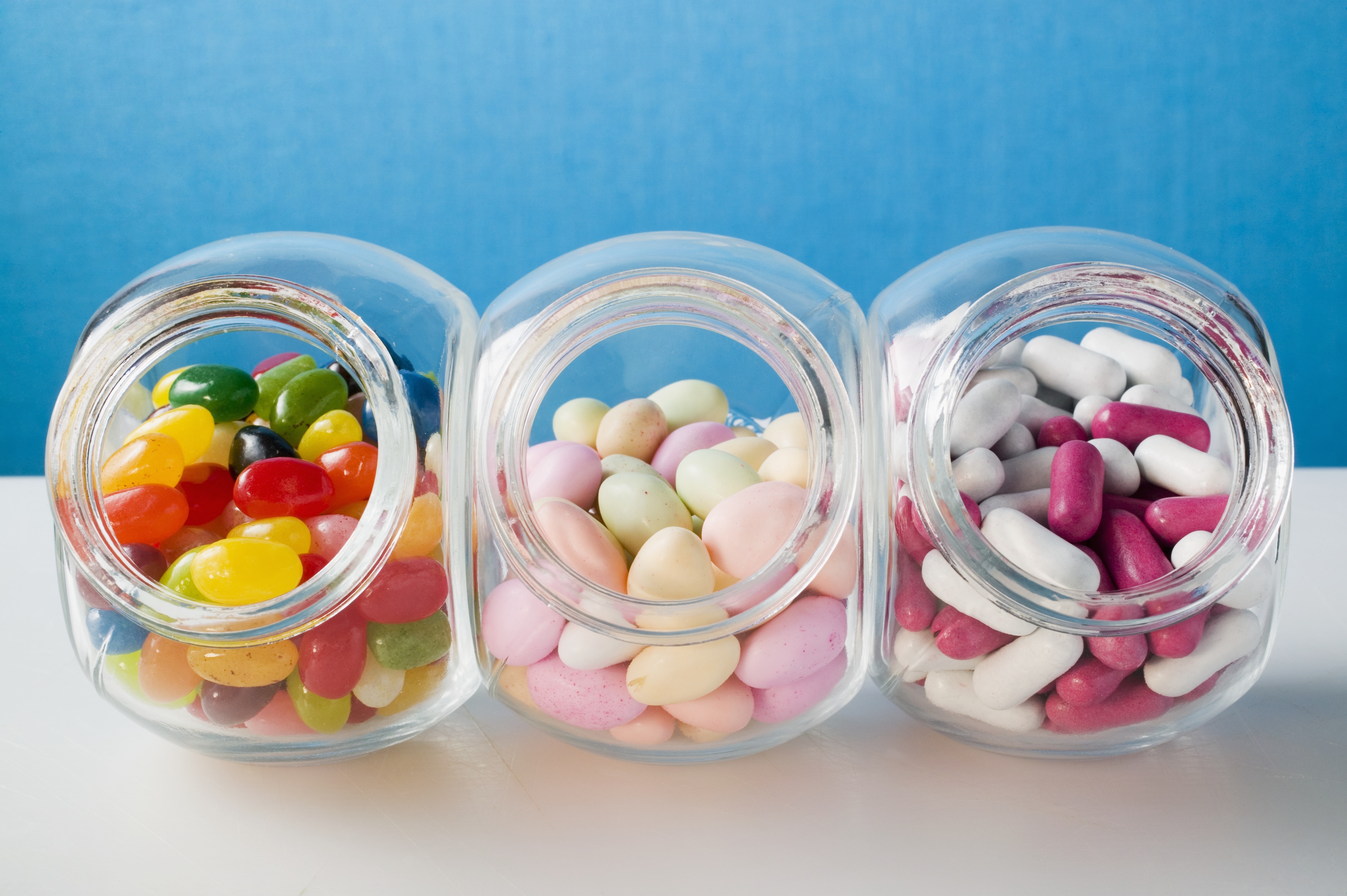 Different kinds of sweets in three sweet jars