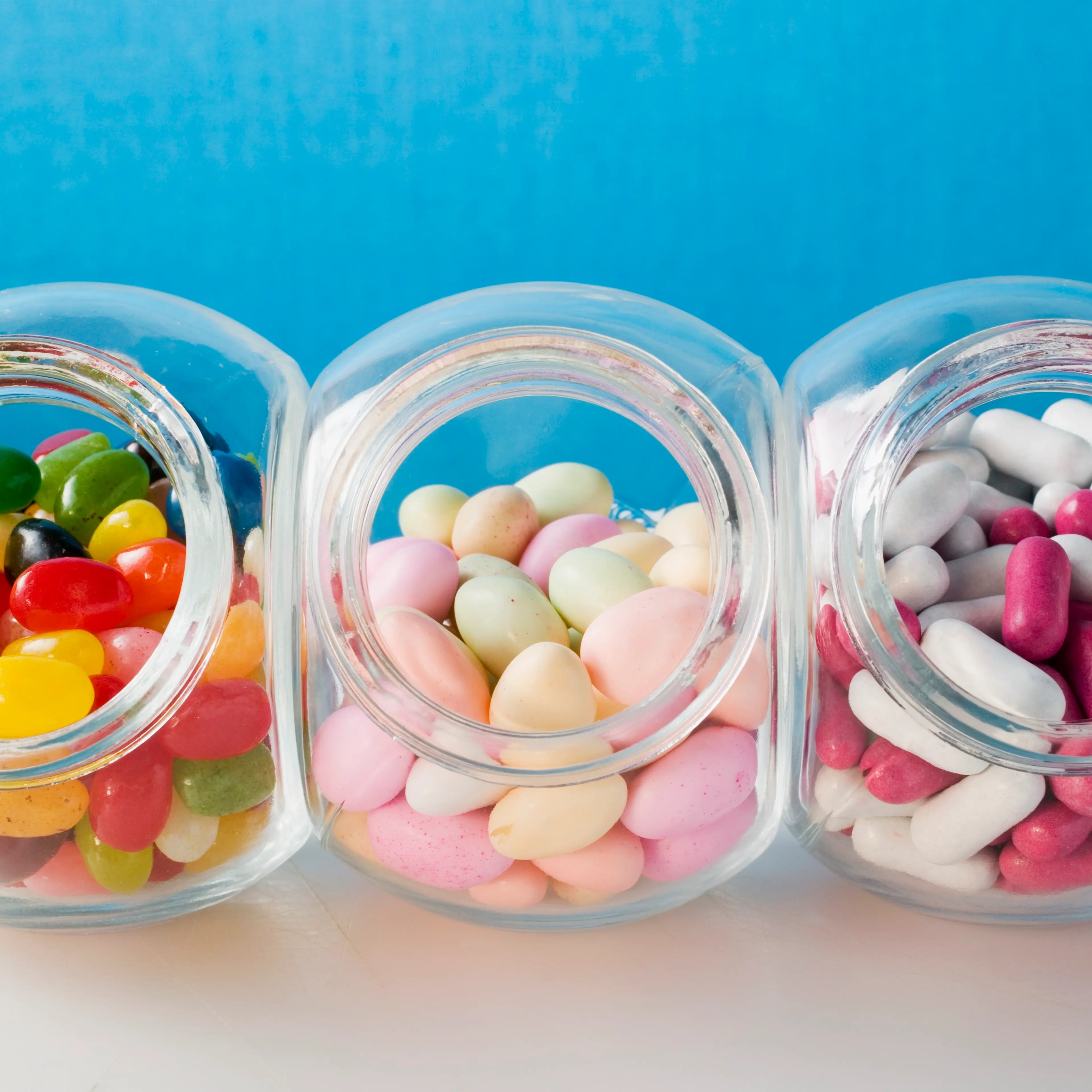 Different kinds of sweets in three sweet jars