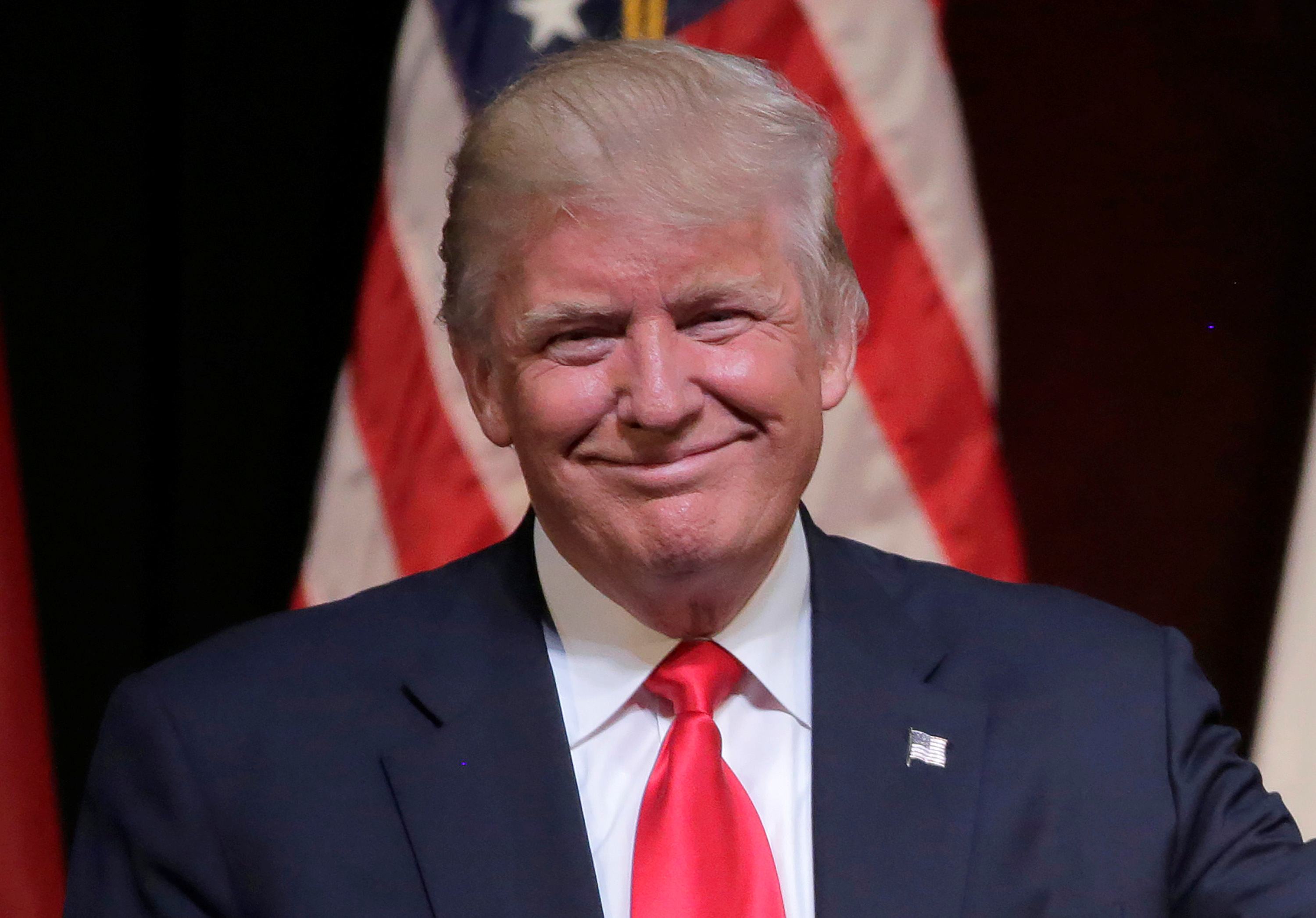 Republican U.S. presidential candidate Donald Trump smiles at a campaign rally in Raleigh.