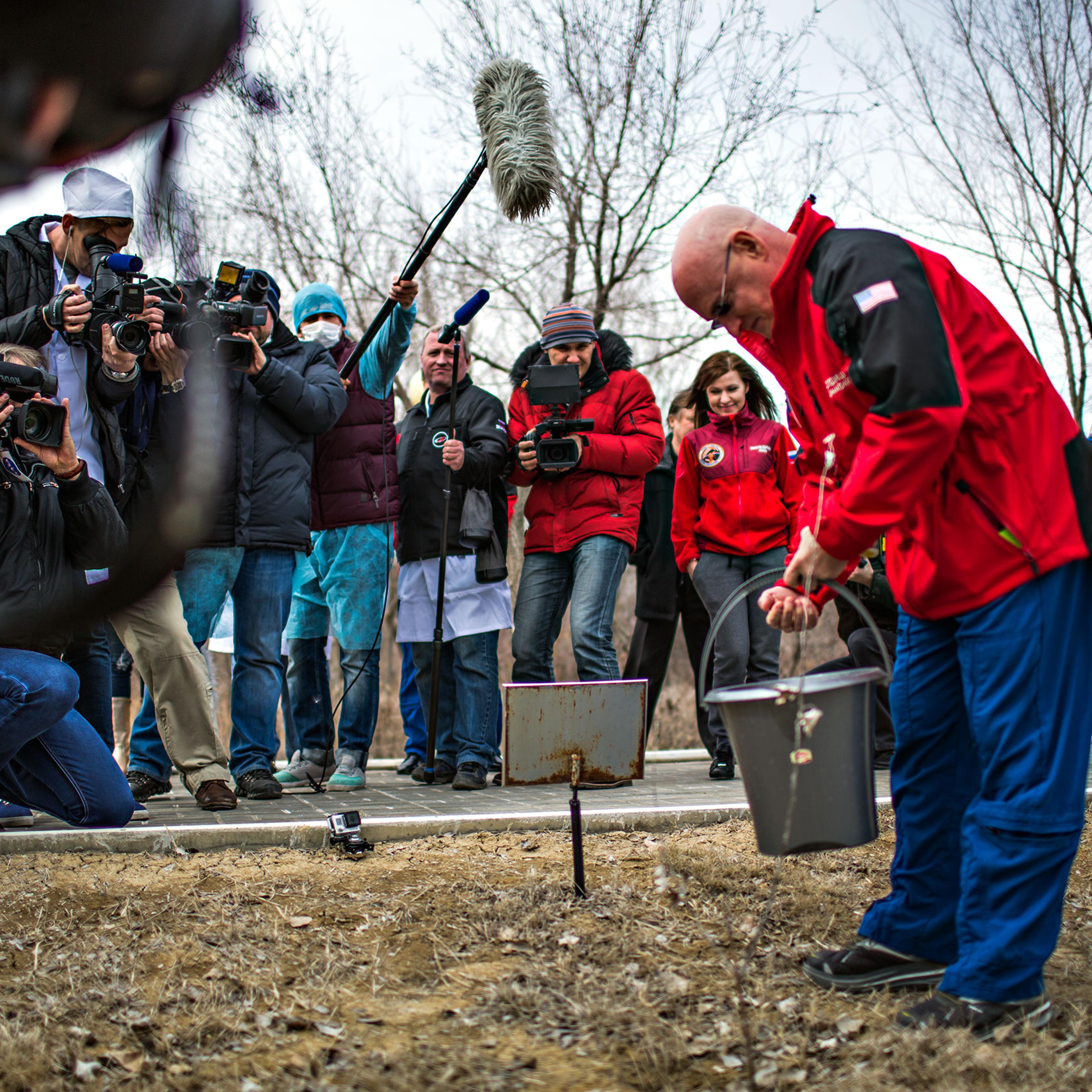 Scott Kelly waters the tree planted in his name in Baikonur, Kazhakstan on Saturday, March 21.