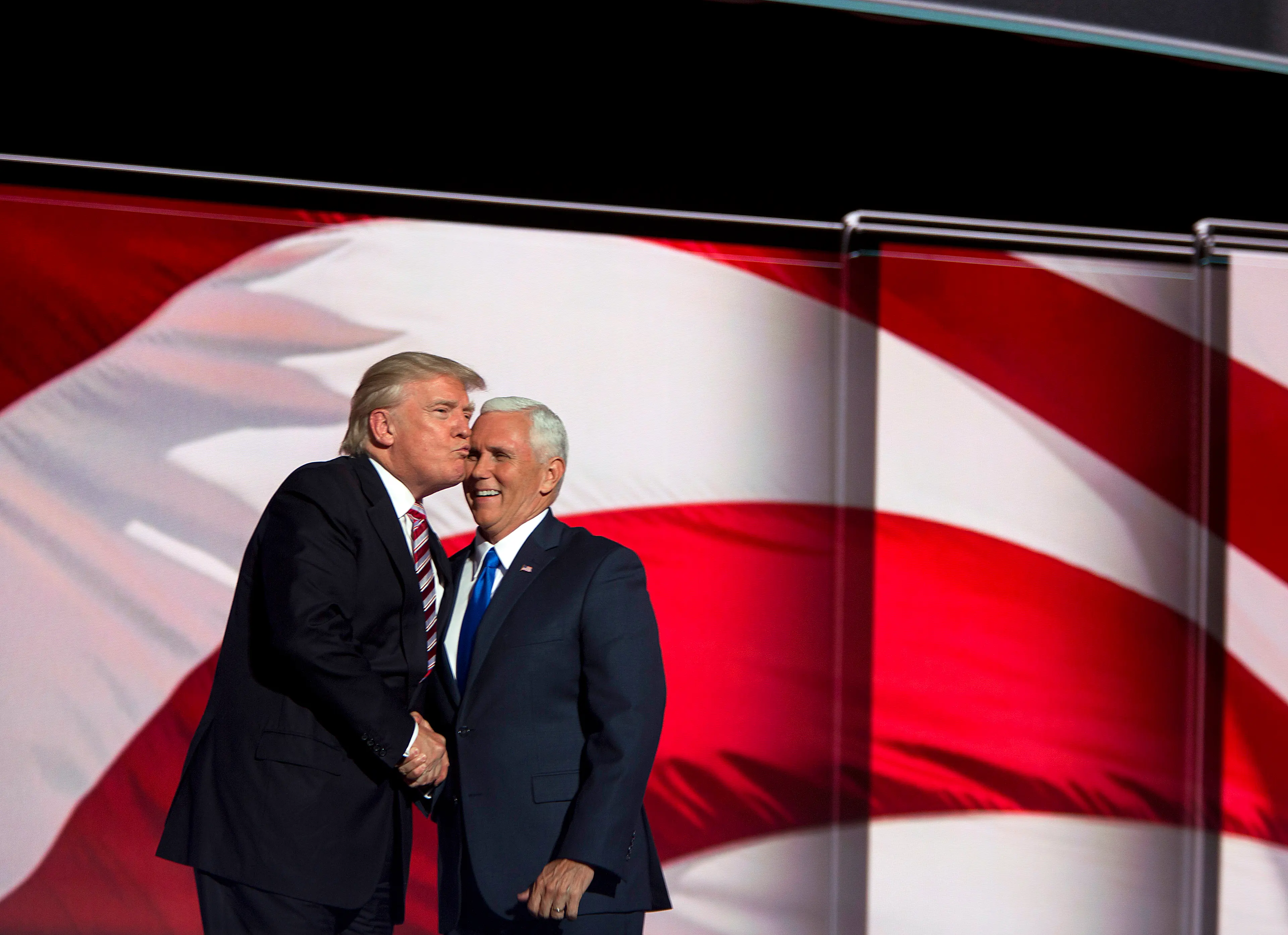 Donald Trump kisses running mate Indiana Gov. Mike Pence at the Republican National Convention on July 20, 2016, in Cleveland.