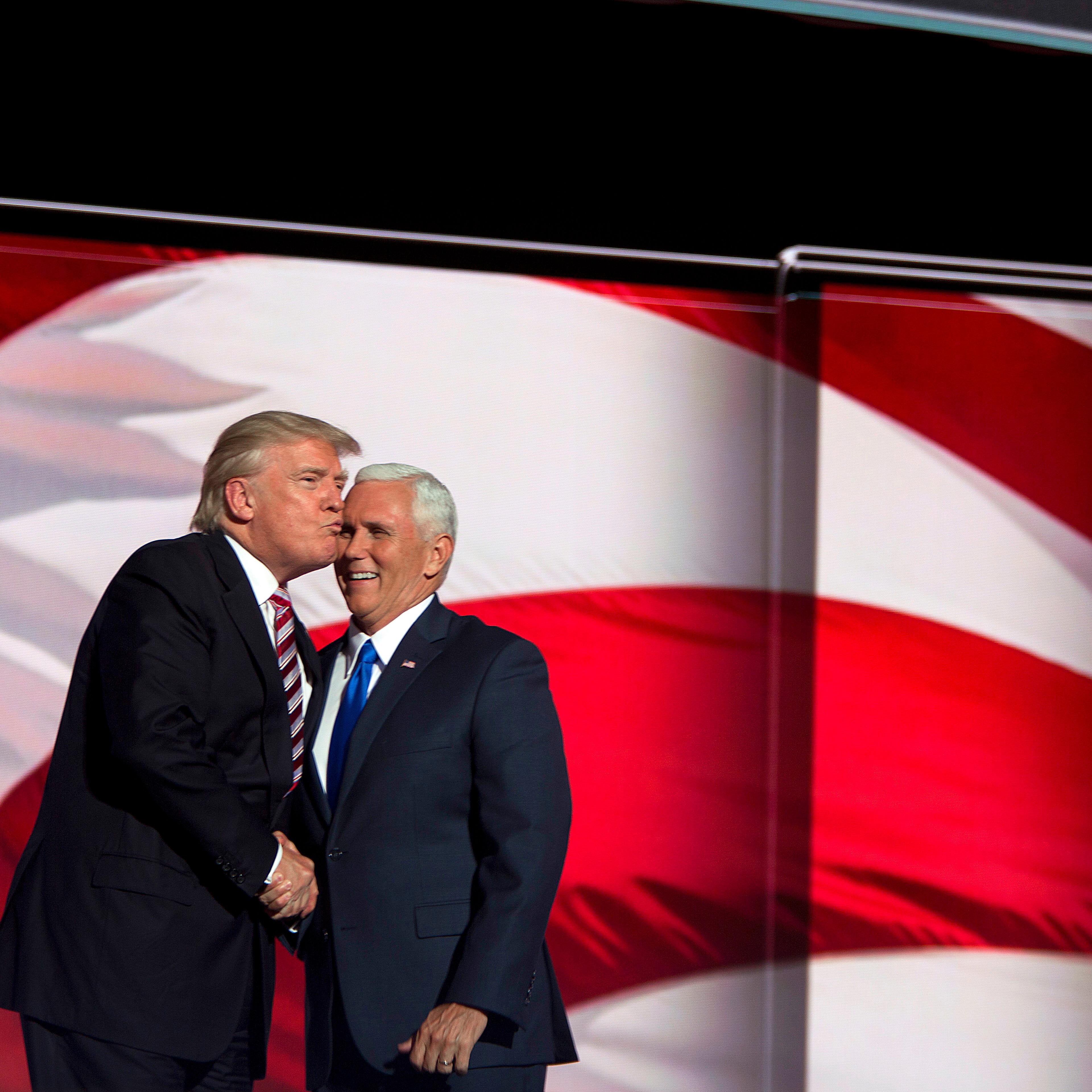 Donald Trump kisses running mate Indiana Gov. Mike Pence at the Republican National Convention on July 20, 2016, in Cleveland.