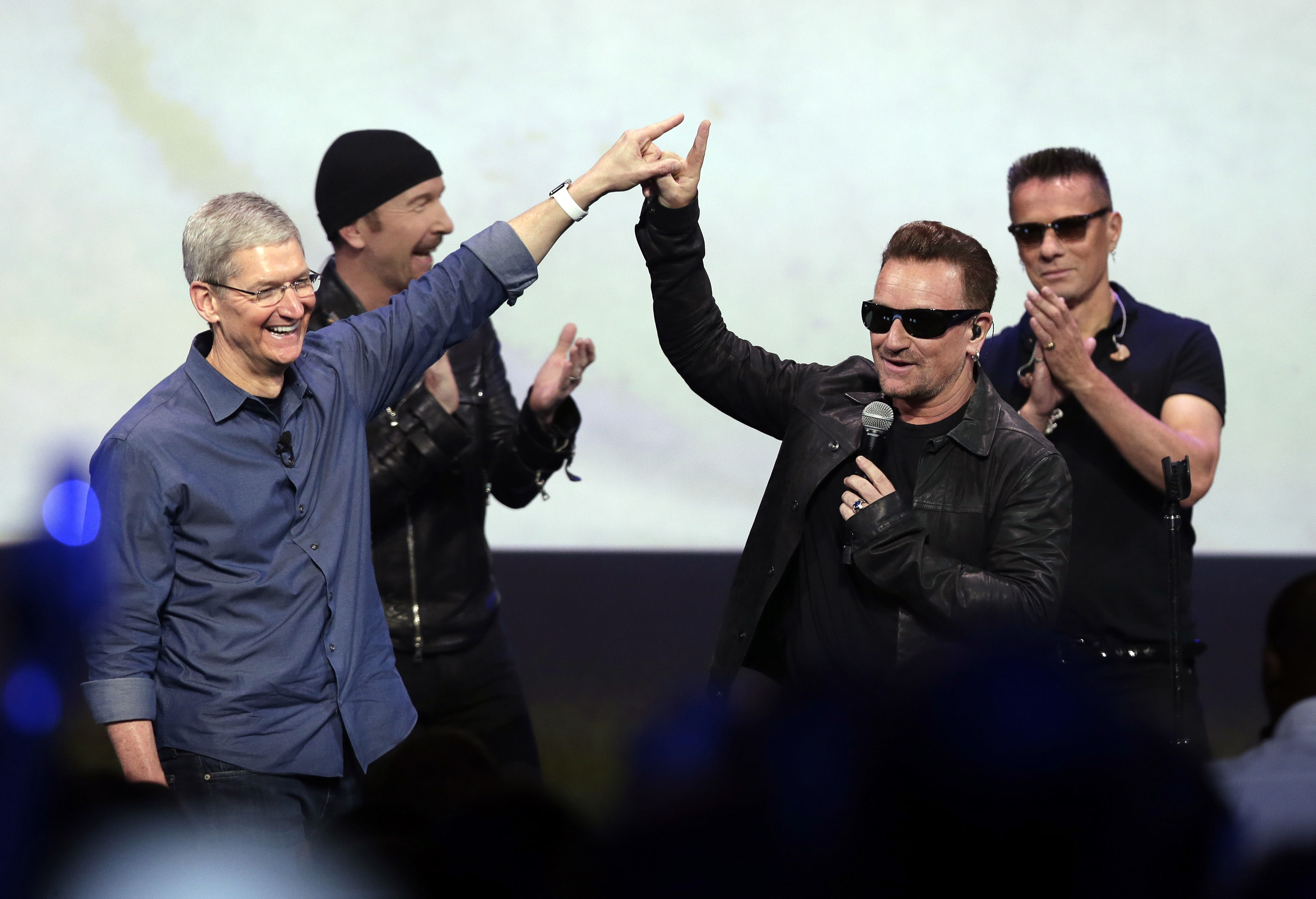 In this Sept. 9, 2014 file photo, Apple CEO Tim Cook (L) greets Bono from the band U2 after they preformed at the end of the Apple event in Cupertino, Calif.
