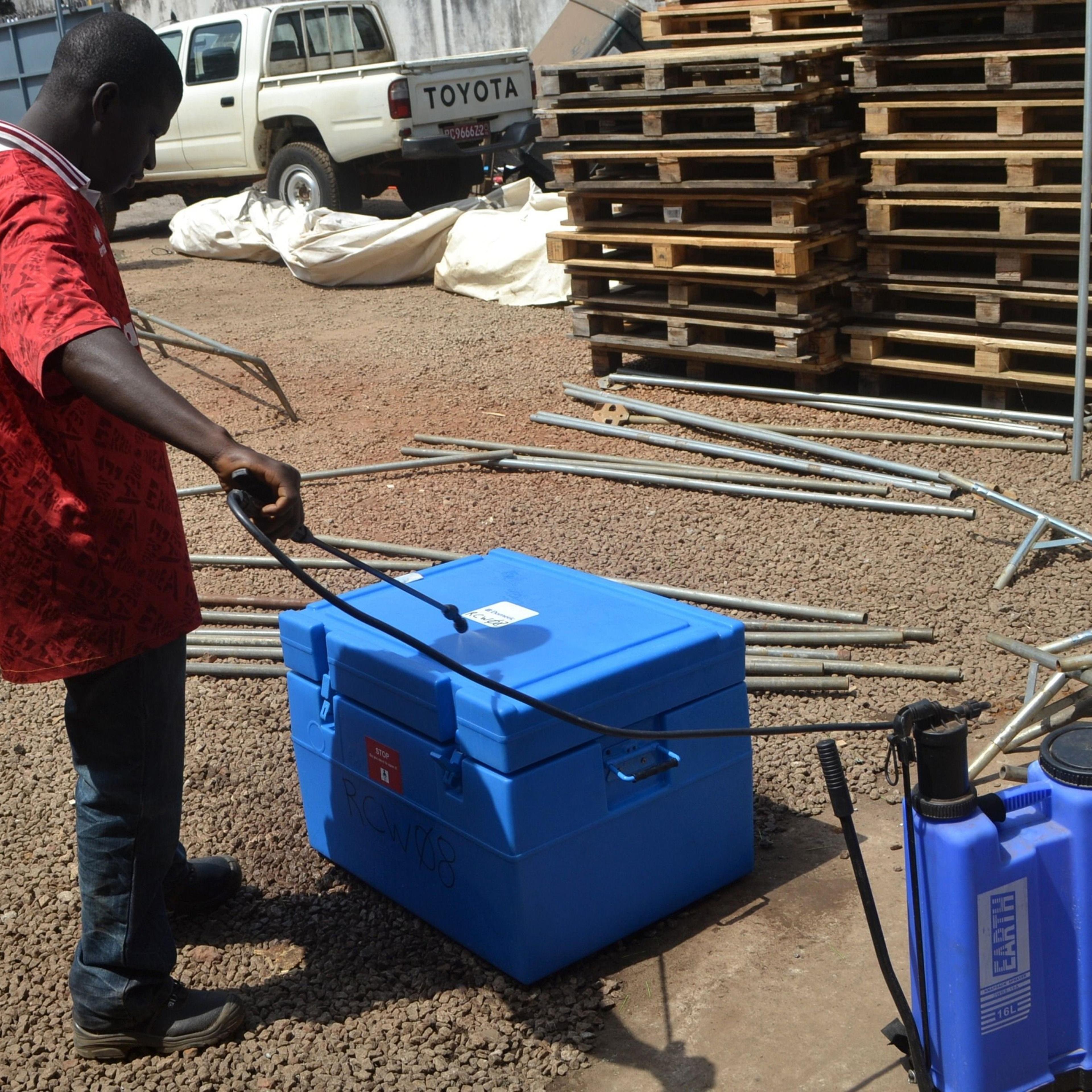 A man desinfects a warehouse of the Swiss branch of the NGO Medecins sans Frontieres in Conakry, Guinea.