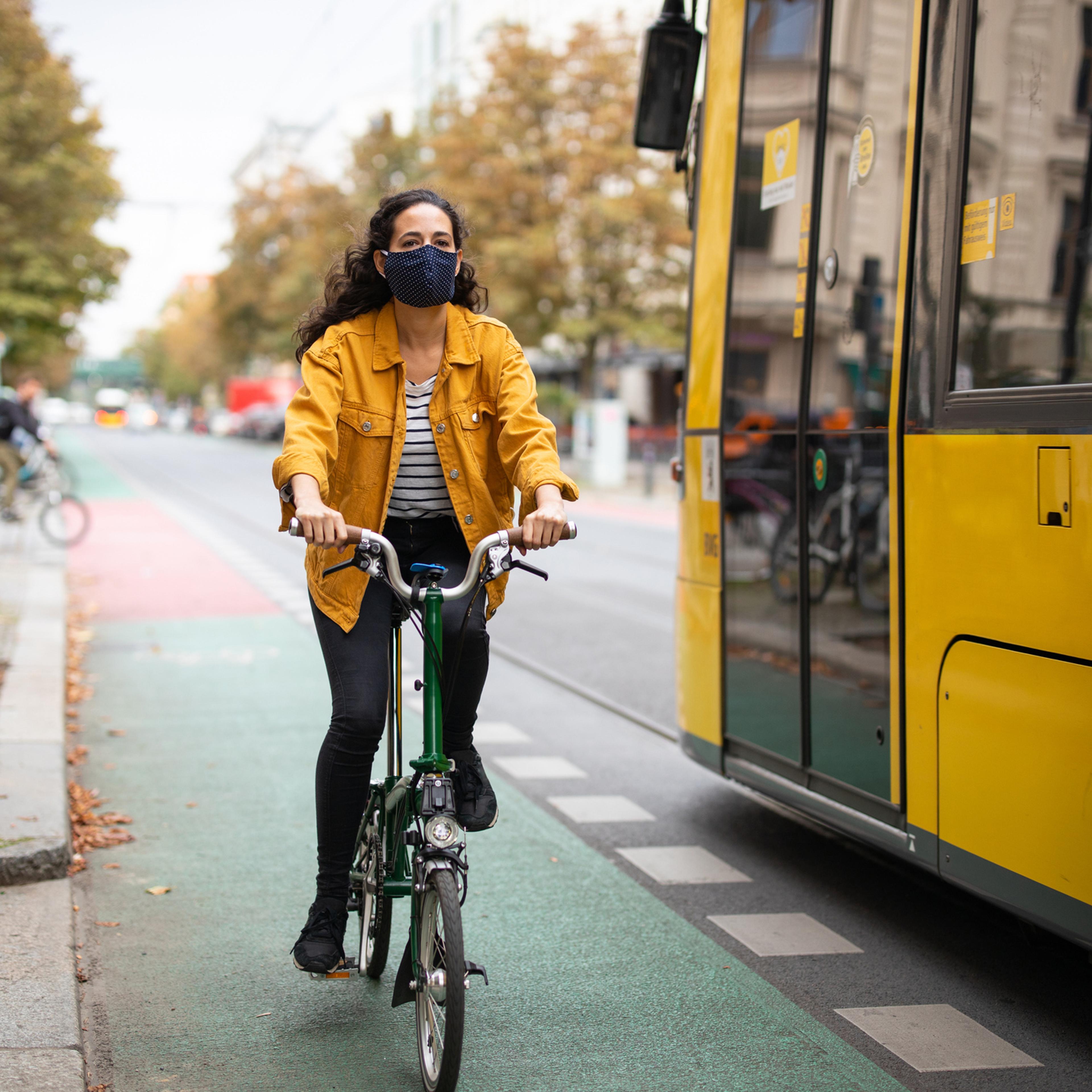 Woman riding a bicycle with a mask on