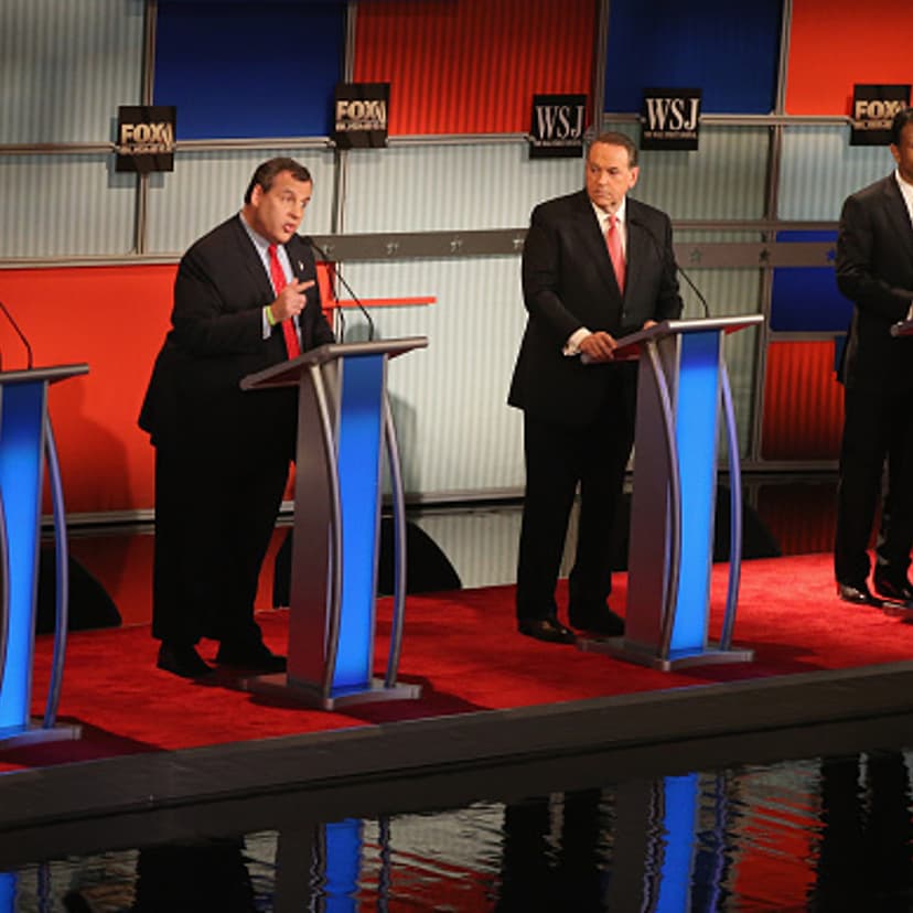 Presidential candidate New Jersey Gov. Chris Christie (2nd L) speaks while Rick Santorum, Mike Huckabee, and Louisiana Gov. Bobby Jindal look on during the Republican Presidential Debate sponsored by Fox Business and the Wall Street Journal at the Milwau