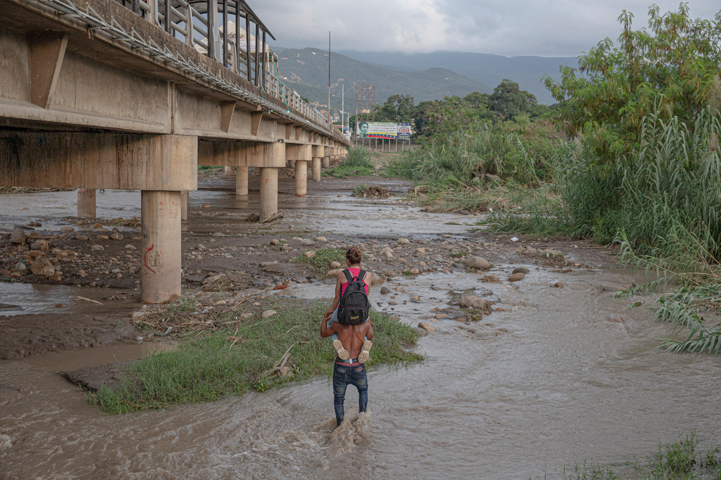 A man carries a woman across the Táchira River, which marks the border between Venezuela and Colombia, in November.