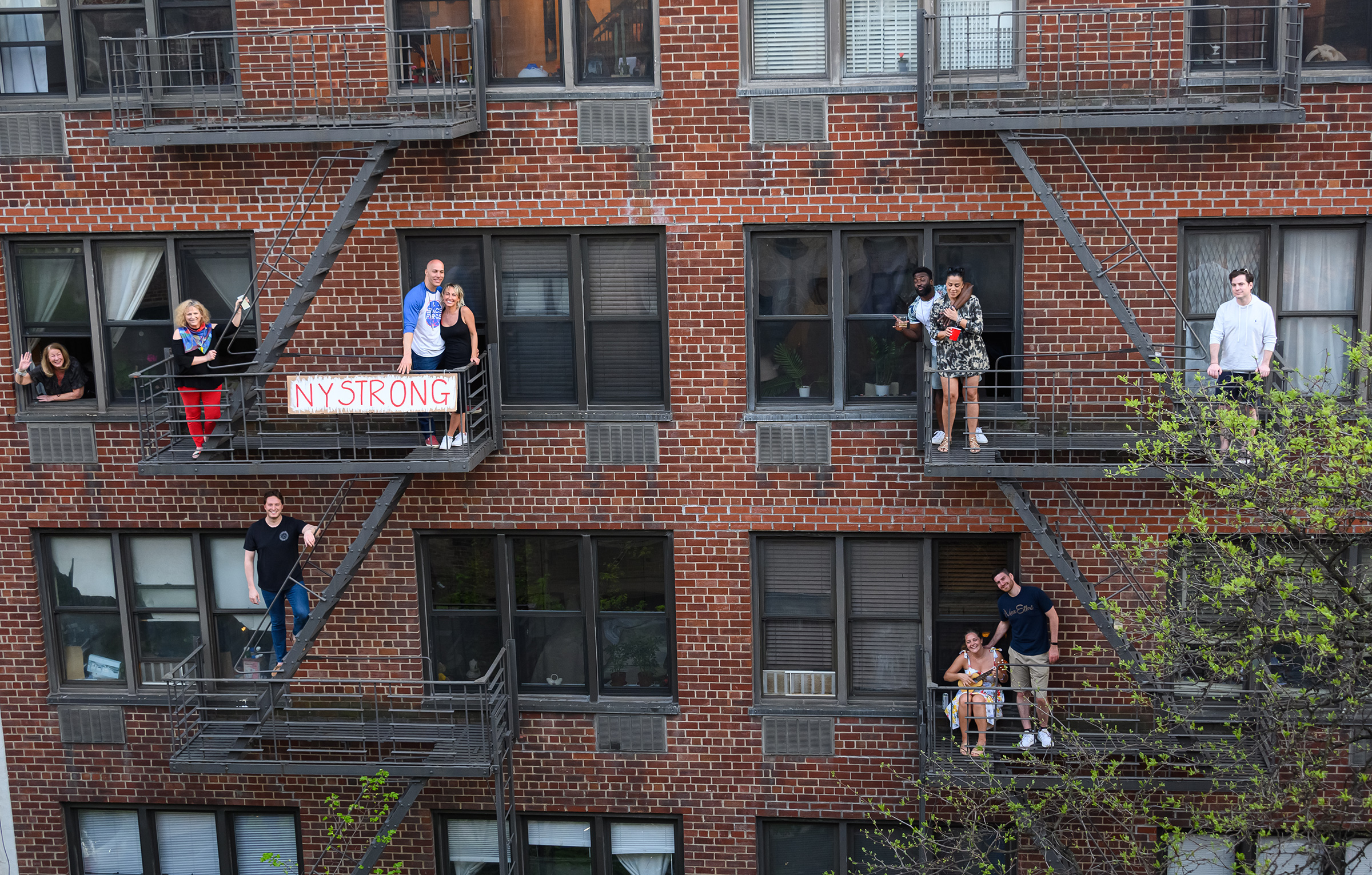 People applaud from their fire escapes to show their gratitude to medical staff and essential workers on the front lines of the coronavirus pandemic during the coronavirus pandemic in the Upper East Side on May 2nd in New York City. 