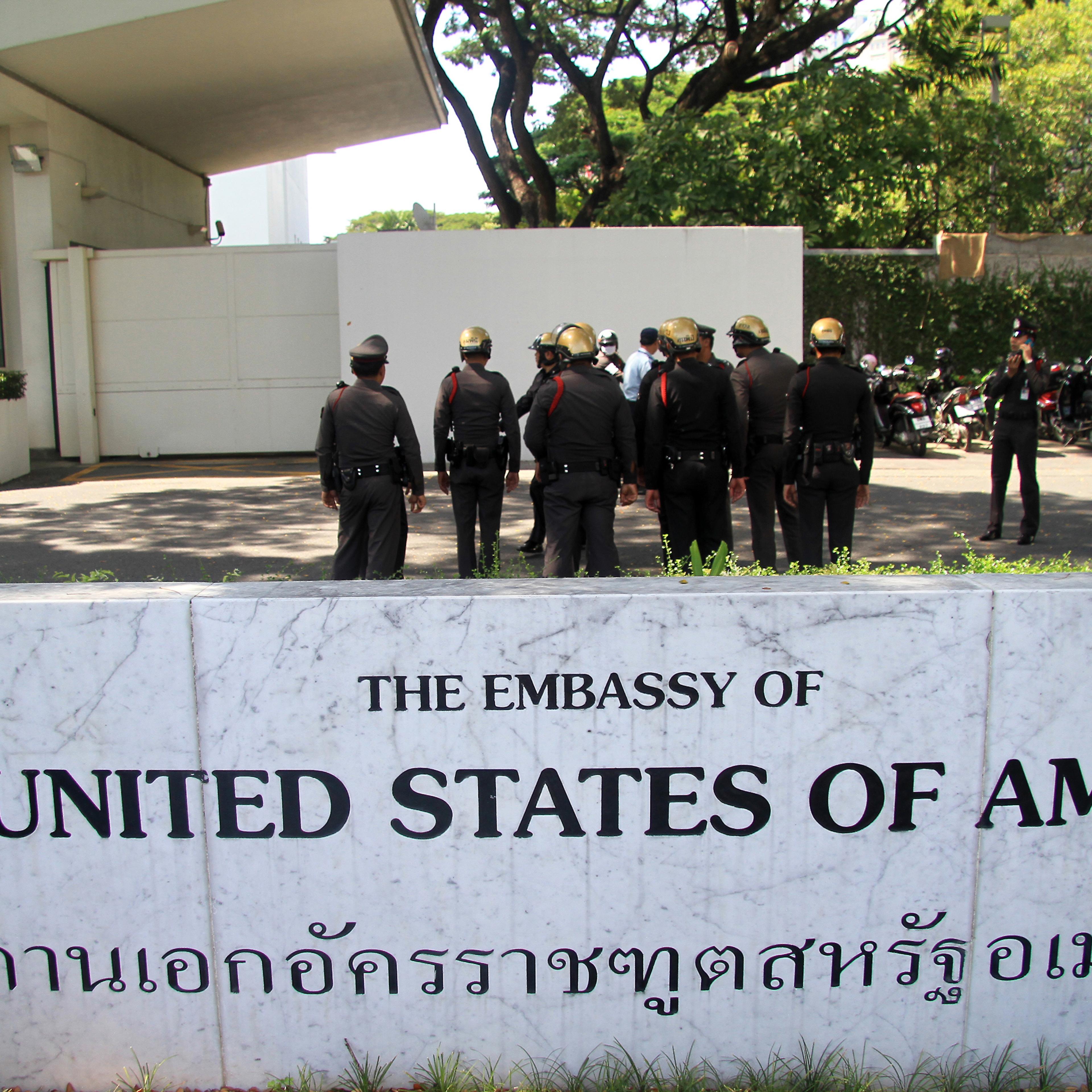 Policemen huddled up in the US Embassy. Buddha Isara