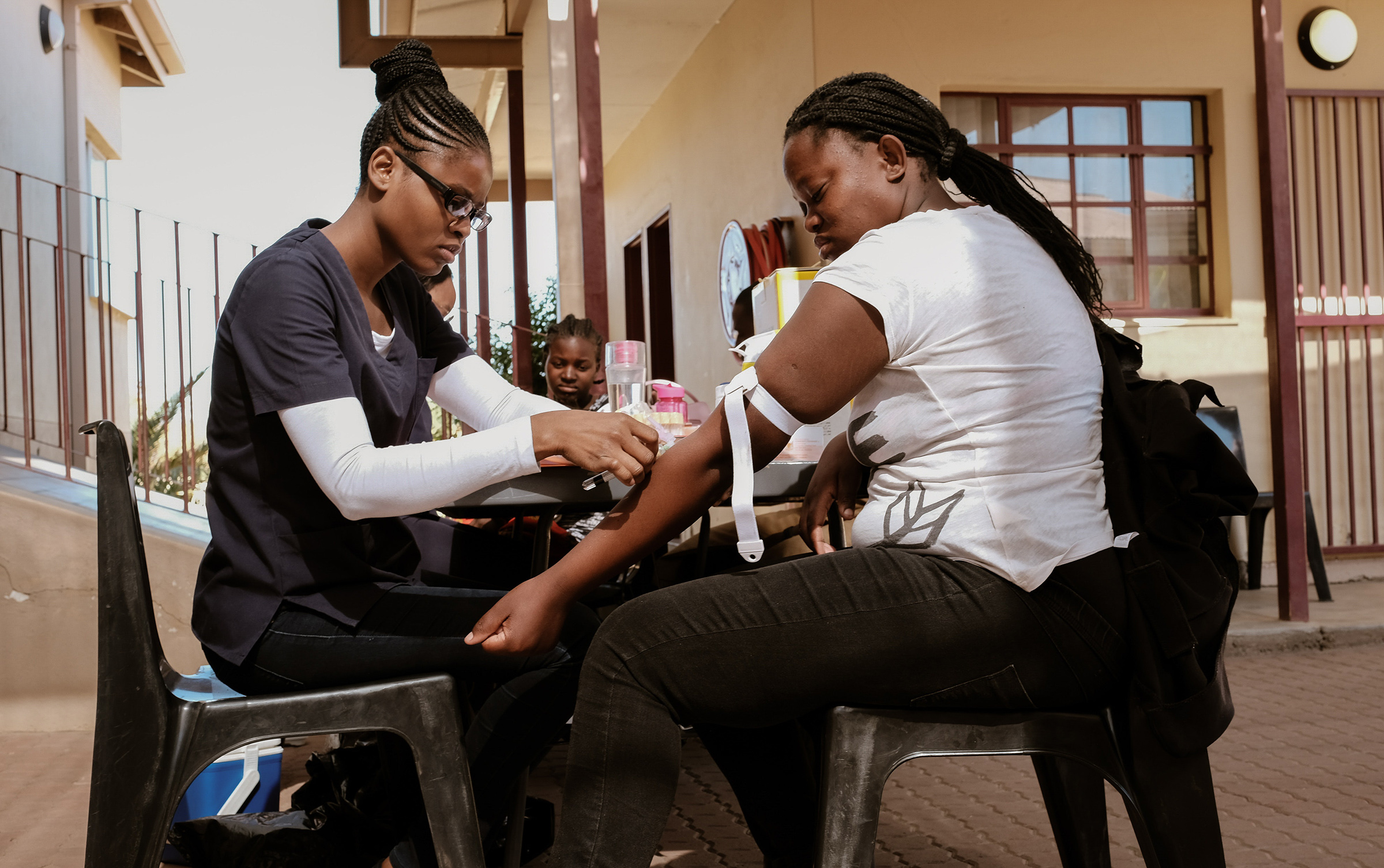 DREAMS program attendee Njandereeko get her blood withdrawn for HIV monitoring. Program attendees are given free medical services of HIV testing, medical assistance, counseling and family planning tools throughout the program.