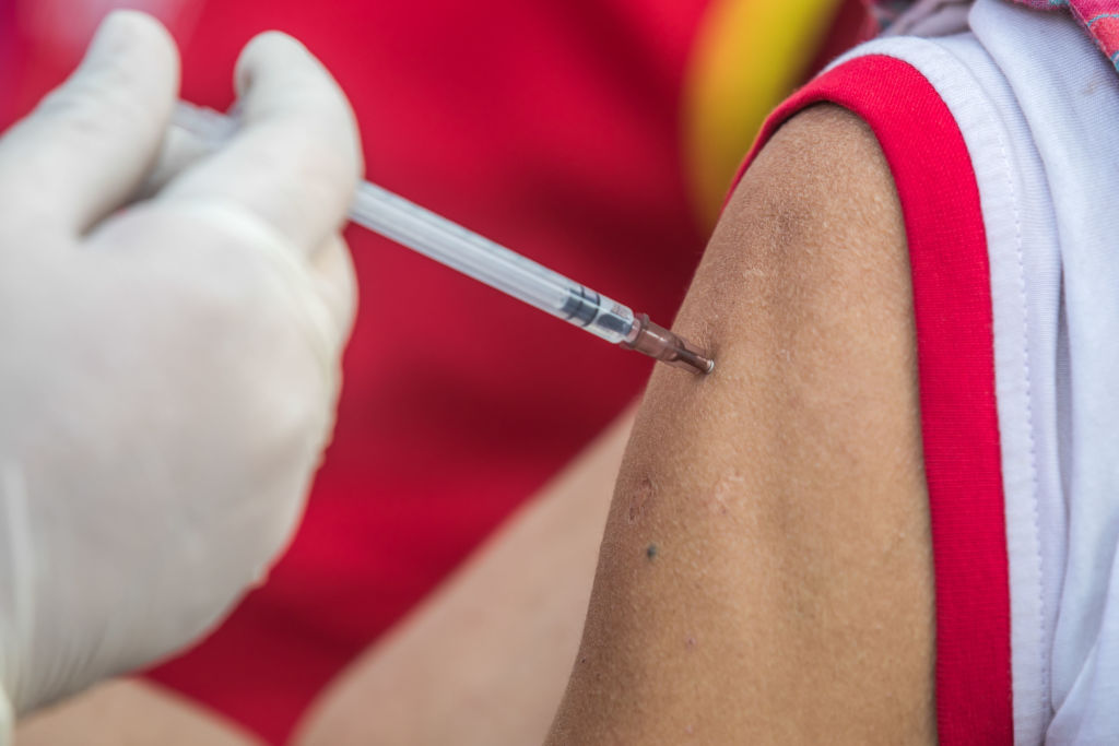 A health worker administers a dose of Janssen COVID-19 vaccine to a homeless person during a vaccination campaign for transgender community and homeless people in Central Shaheed Minar, Dhaka, Bangladesh.