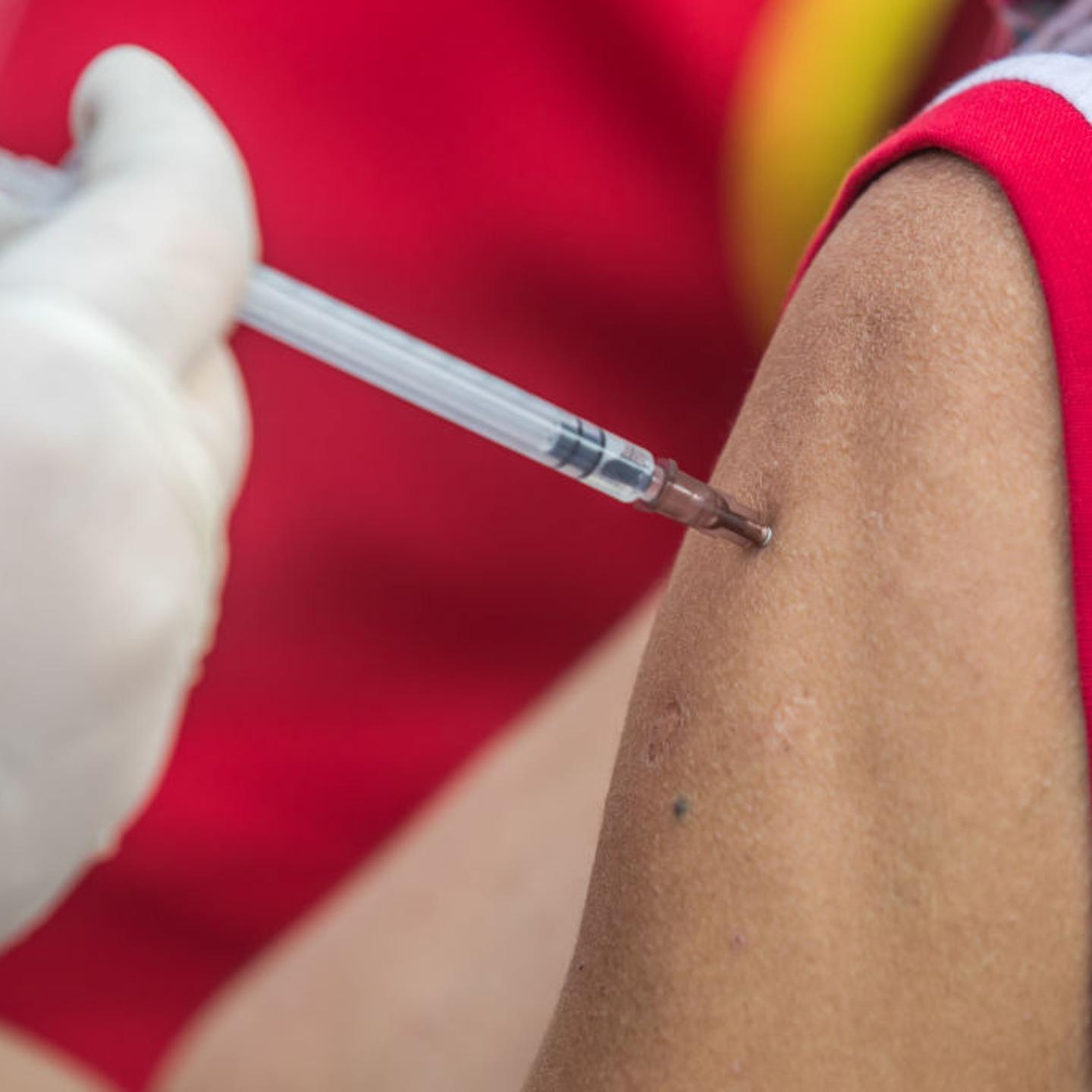 A health worker administers a dose of Janssen COVID-19 vaccine to a homeless person during a vaccination campaign for transgender community and homeless people in Central Shaheed Minar, Dhaka, Bangladesh.