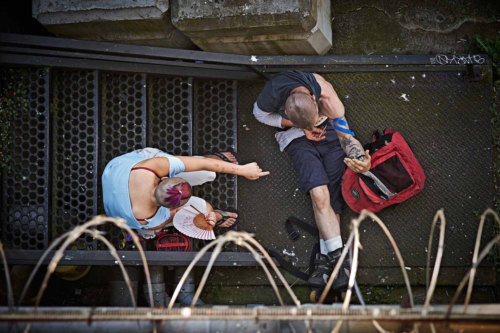 A man injects himself while a woman looks on. July, 2014.