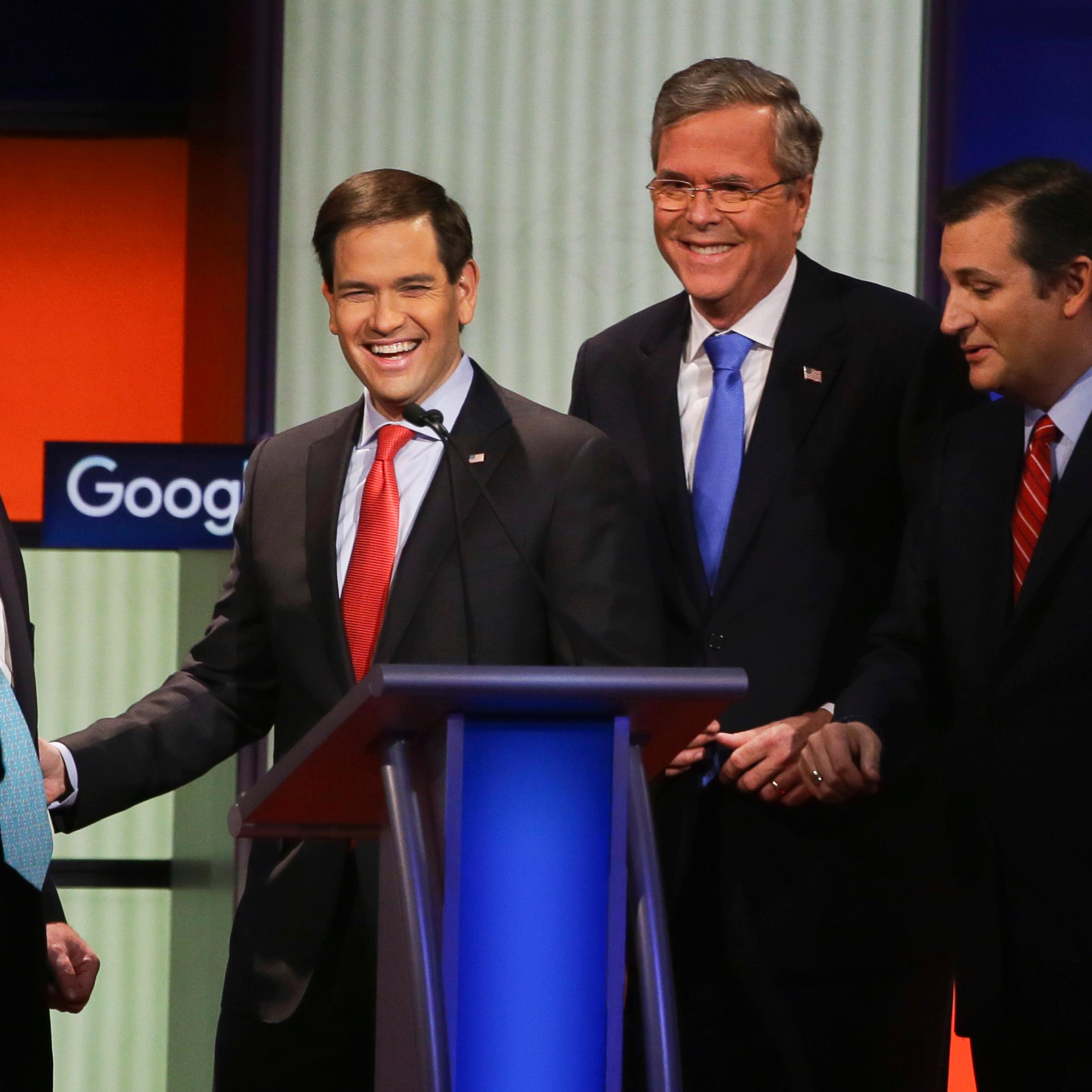 Republican presidential candidates, from left, New Jersey Gov. Chris Christie, Sen. Marco Rubio, R-Fla., former Florida Gov. Jeb Bush and Sen. Ted Cruz, R-Texas, talk after the Republican presidential primary debate, Thursday, Jan. 28, 2016, in Des Moine