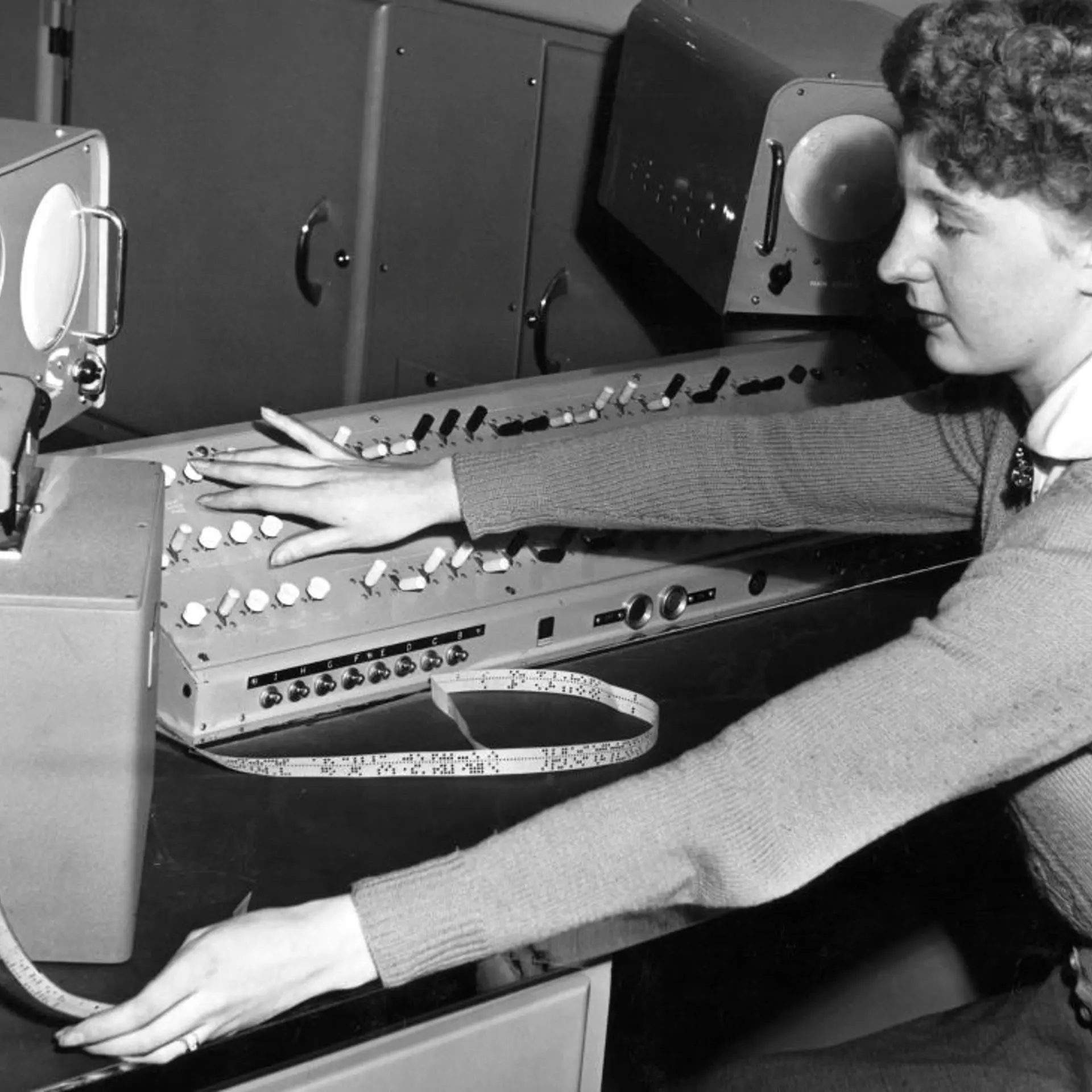 Female computer operator feeding instructions to �The Brain�, May 1955.