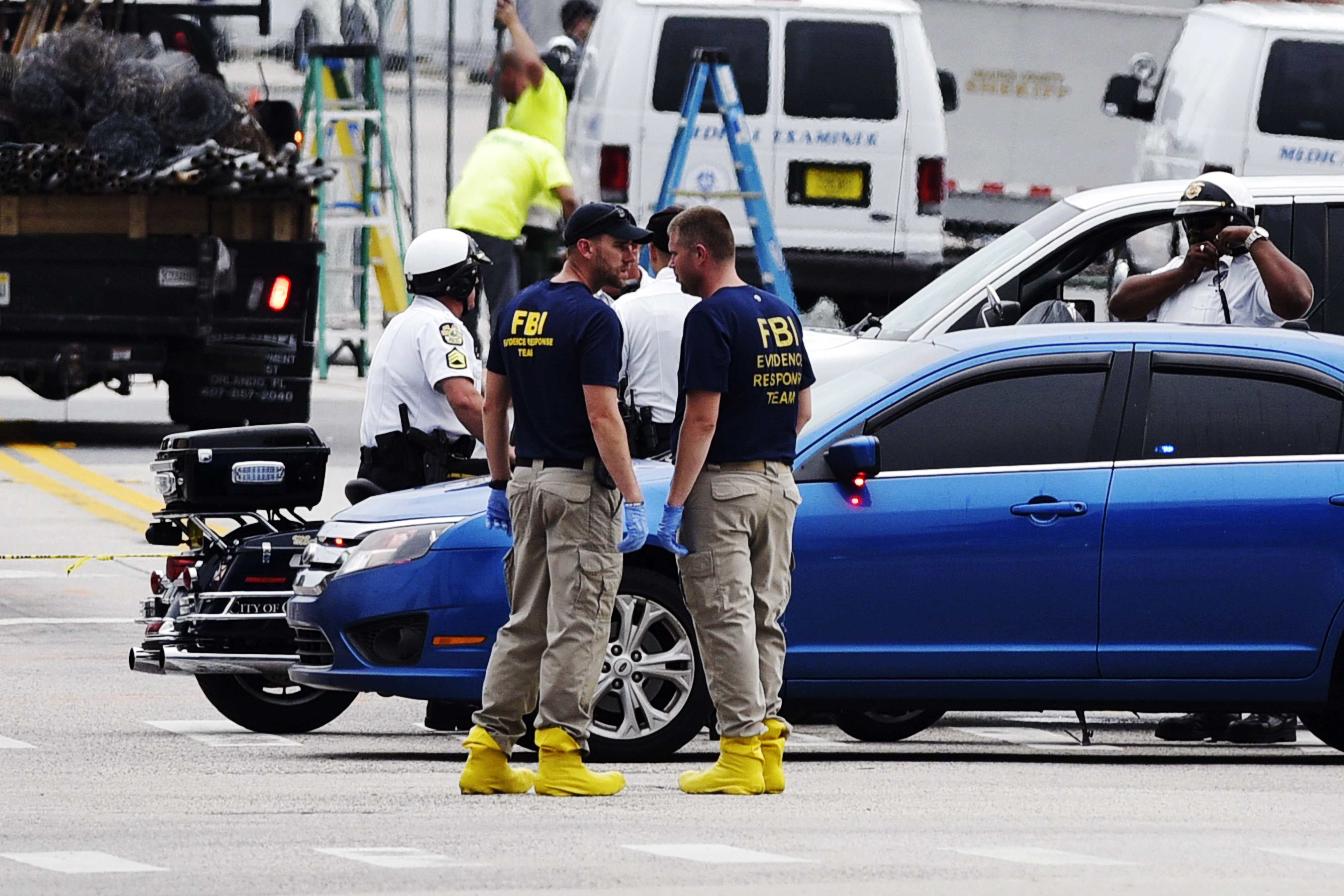 Police and investigators work near the area of the mass shooting at the Pulse nightclub on in Orlando, Fla. on June 12, 2016.