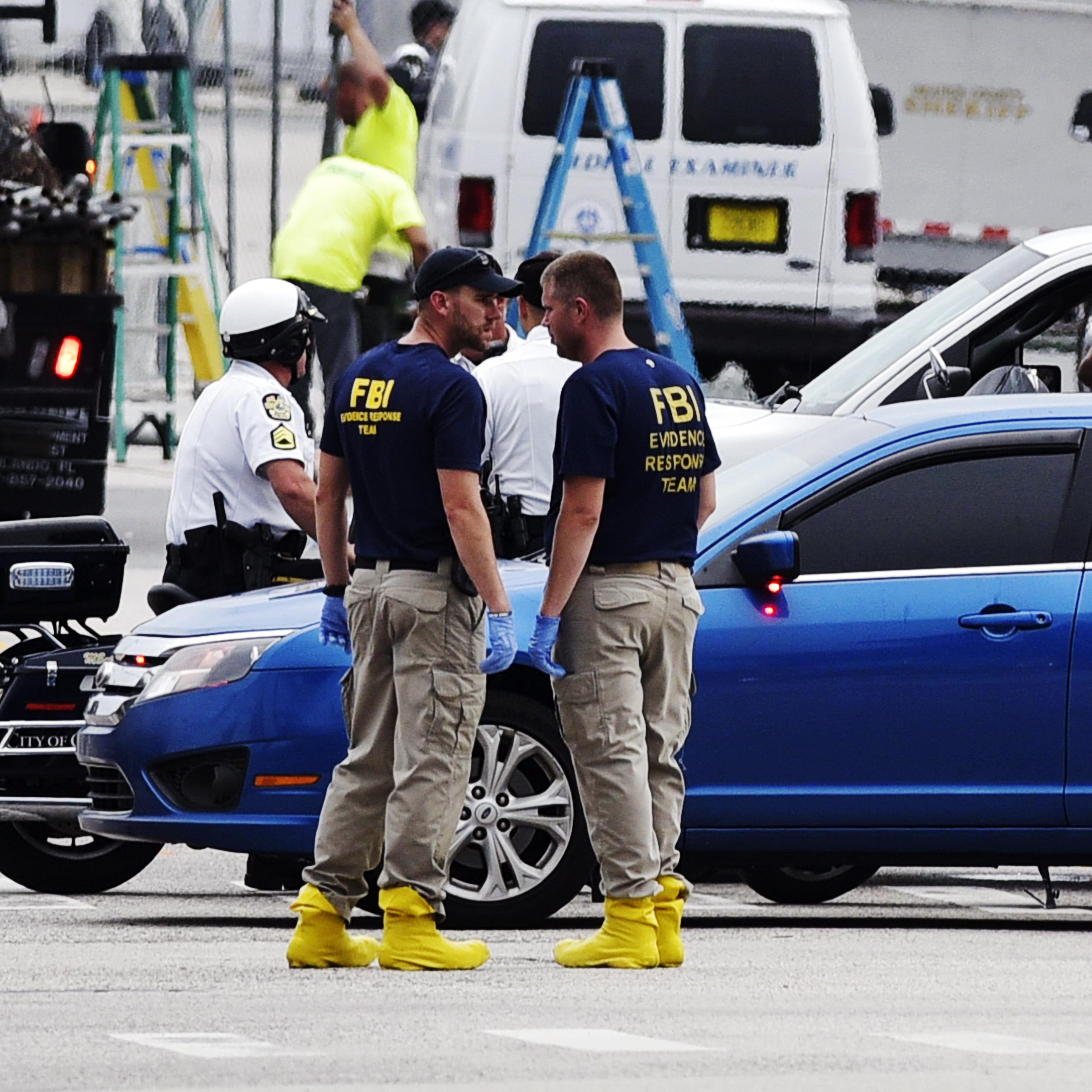 Police and investigators work near the area of the mass shooting at the Pulse nightclub on in Orlando, Fla. on June 12, 2016.